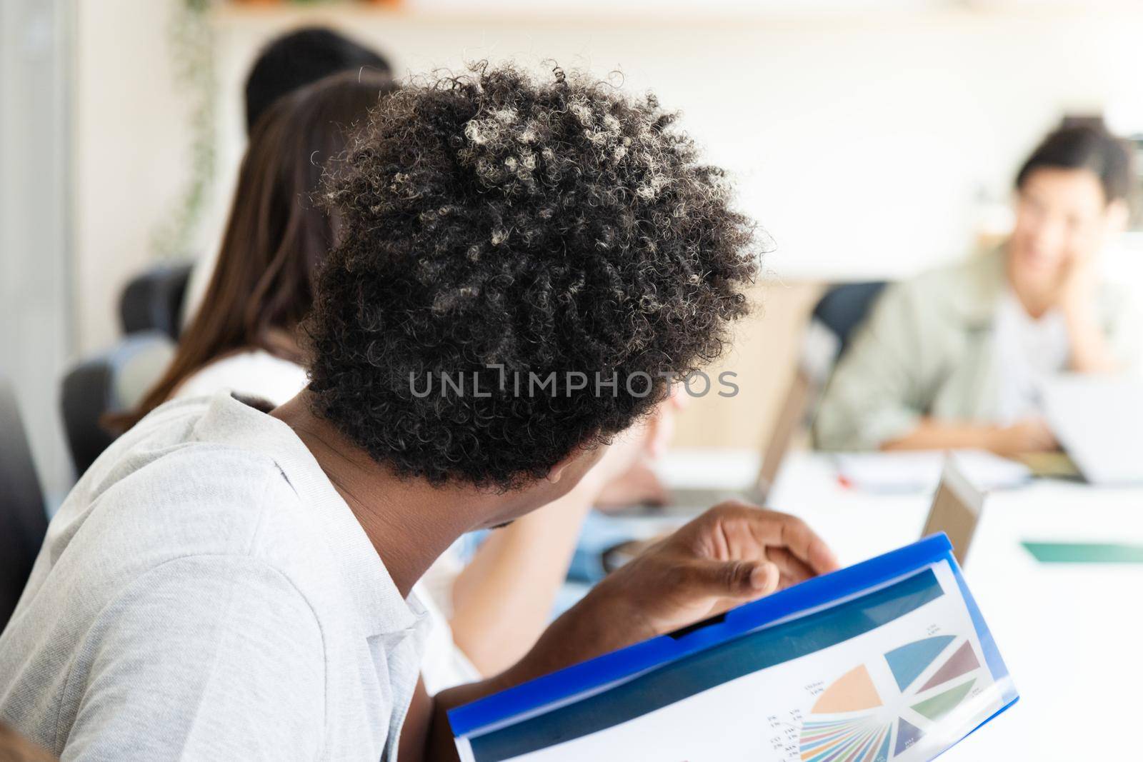 African american man in company meeting holding documents. Business meeting concept.