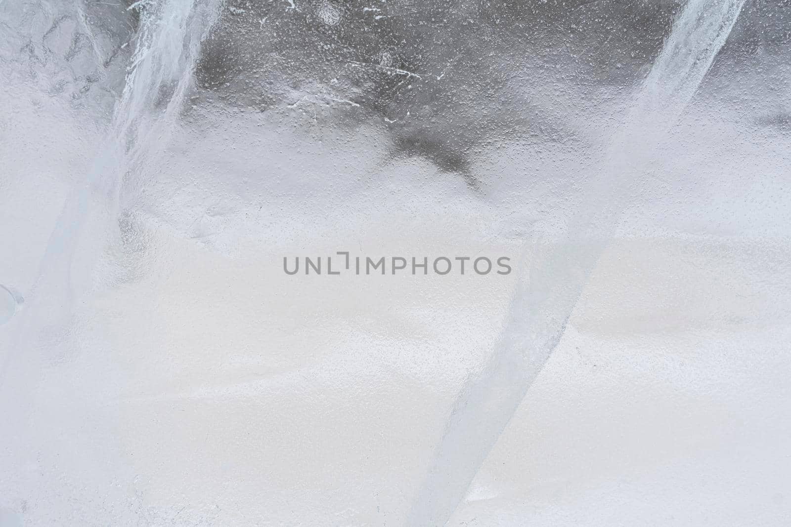 Beautiful ice of Lake with abstract cracks