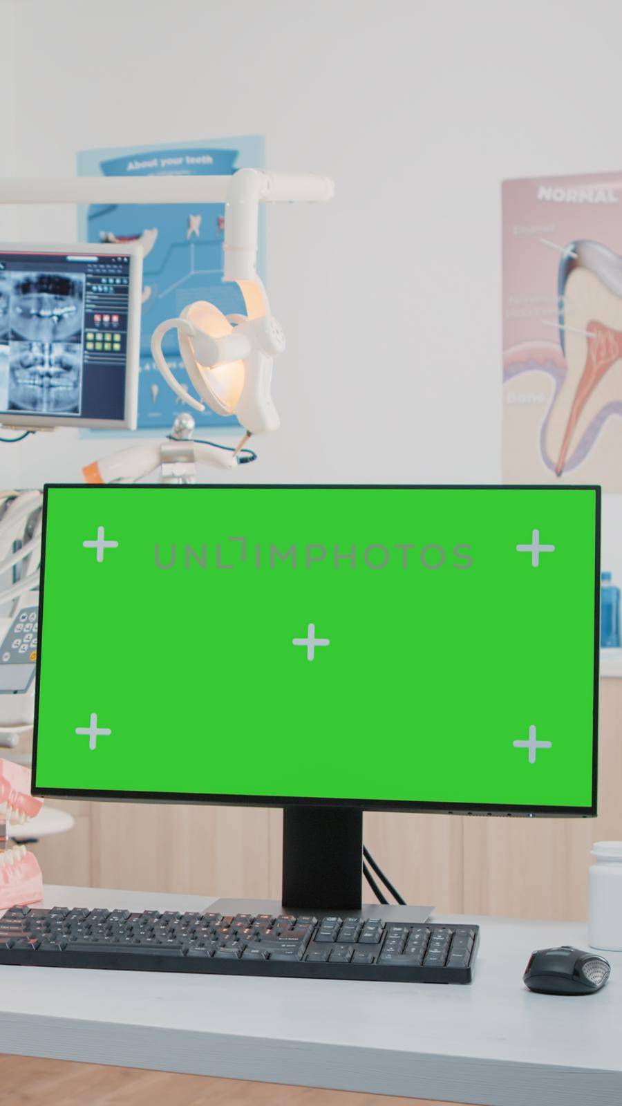 Horizontal green screen on computer in dentist office while specialists using equipment for dental care. Monitor with chroma key and isolated mockup template in office for teethcare.