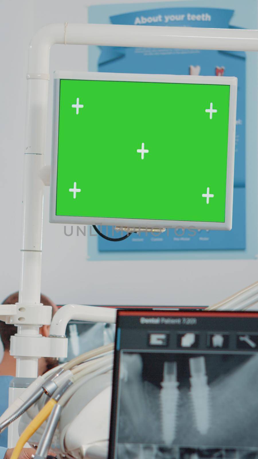 Woman working as dentist with green screen and x ray scan by DCStudio