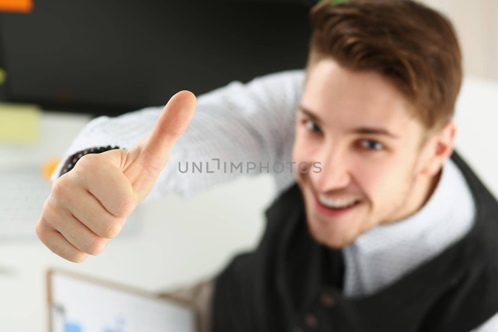 Male showing thumbs up sign with hand, cheerful office worker by kuprevich