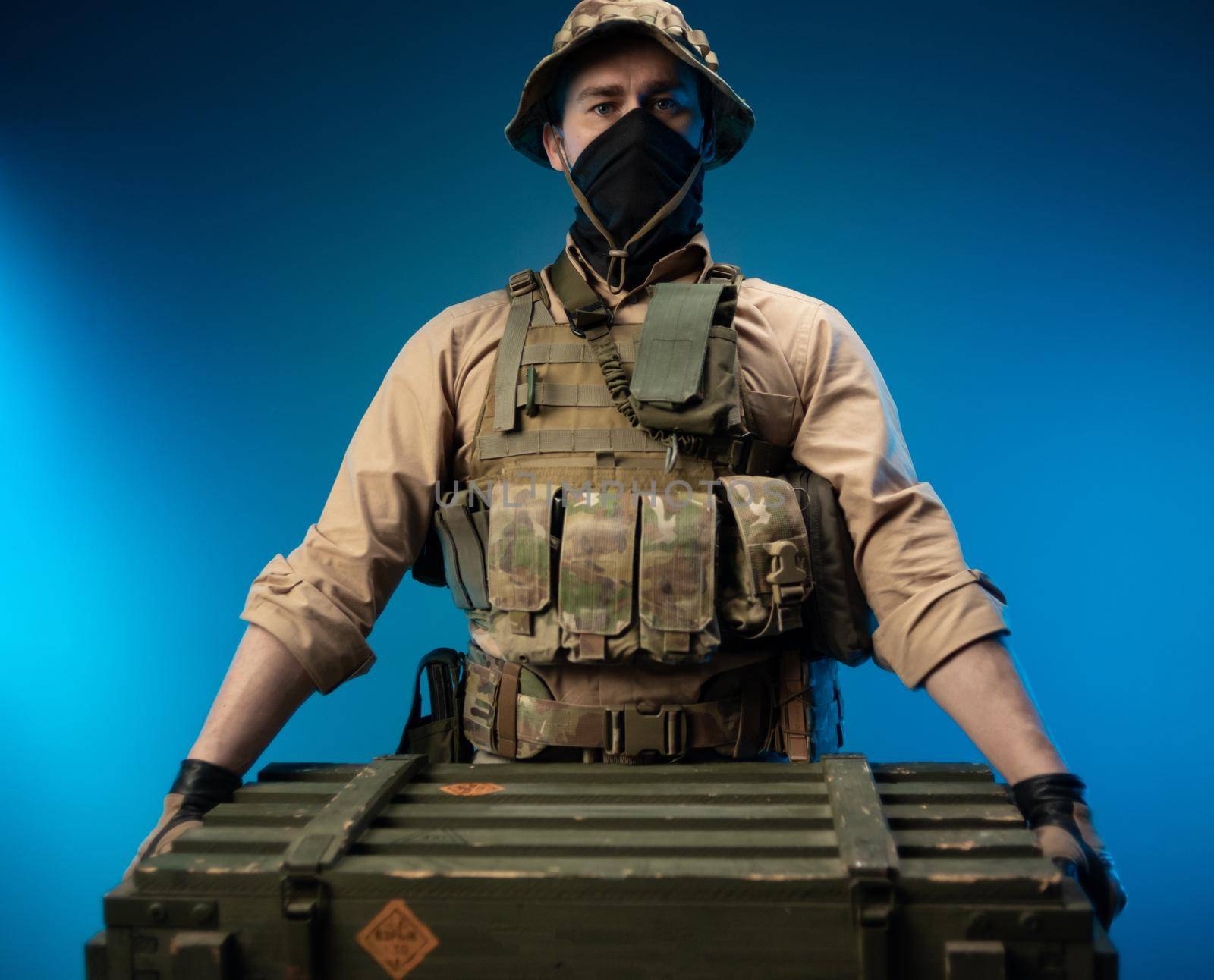 an army soldier in military clothes with a box of ammunition on his shoulder by Rotozey