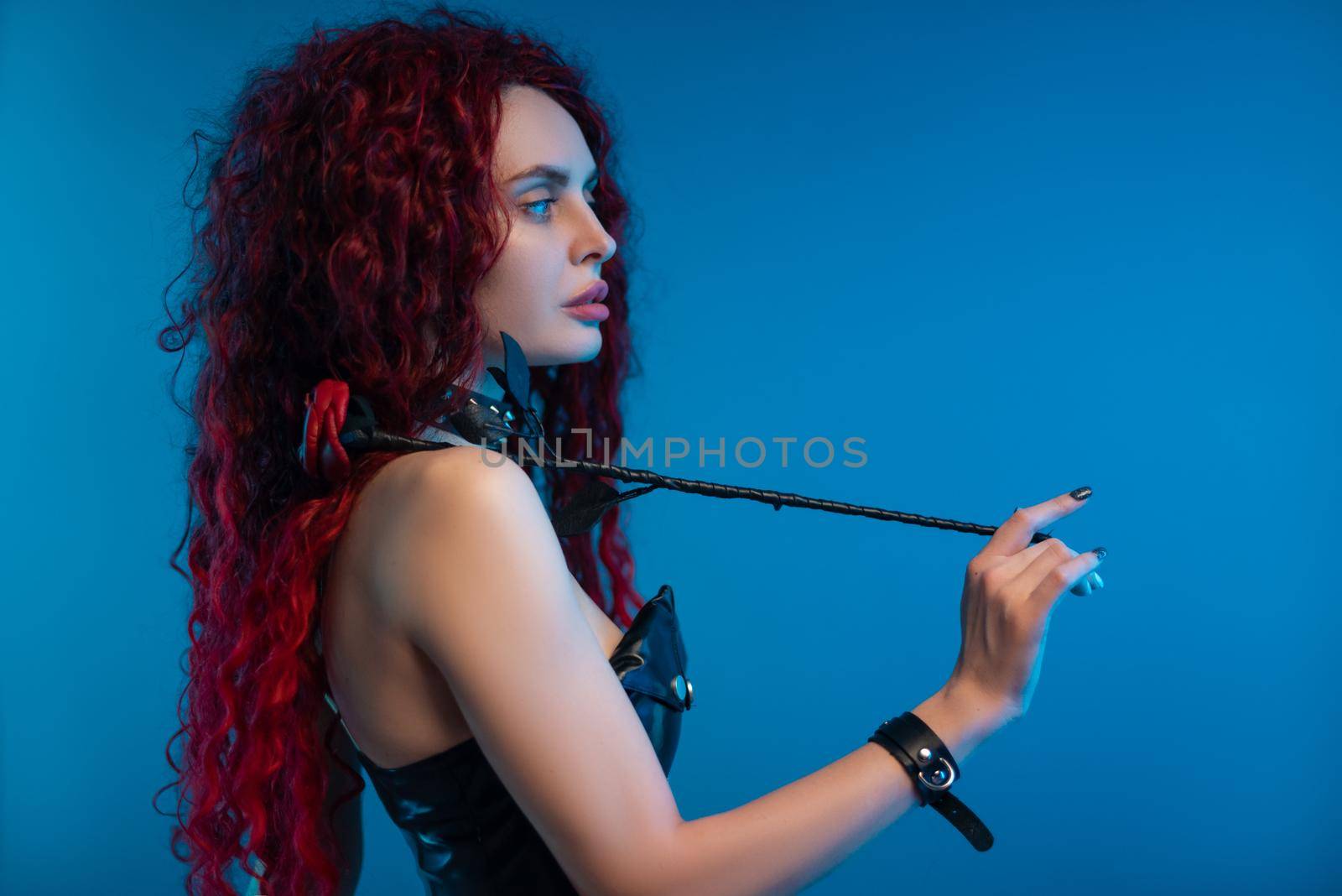 portrait of a girl with a chic hairstyle and red hair with a leather rose in her hands by Rotozey