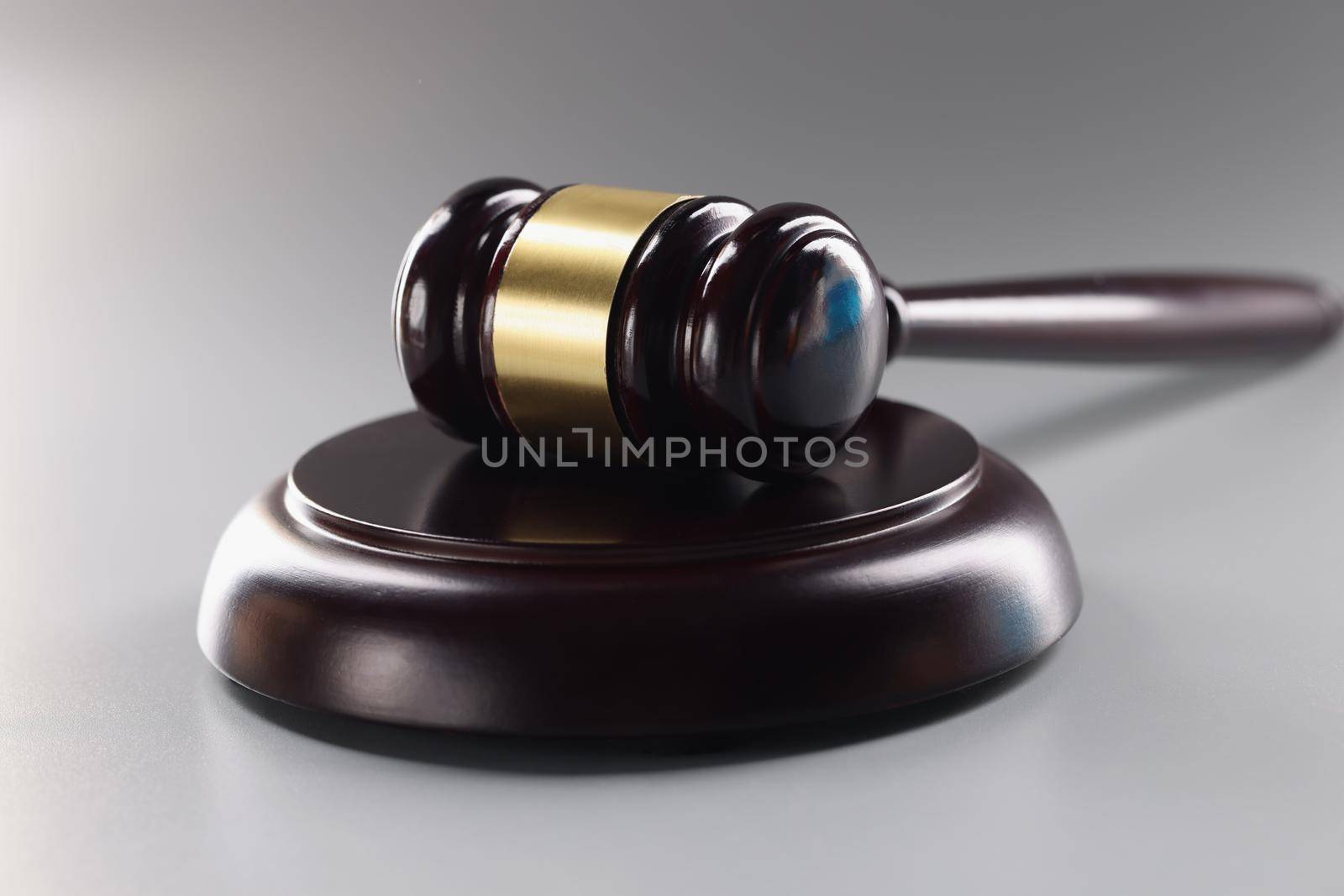 Judge black wooden hammer on soundboard on grey background, attorney instrument for legal service by kuprevich