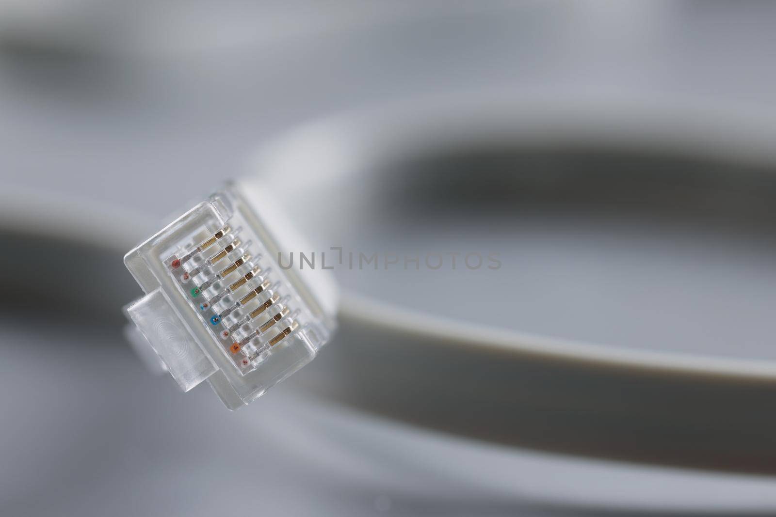 Internet connector on grey background, focus on cable with plastic clip by kuprevich