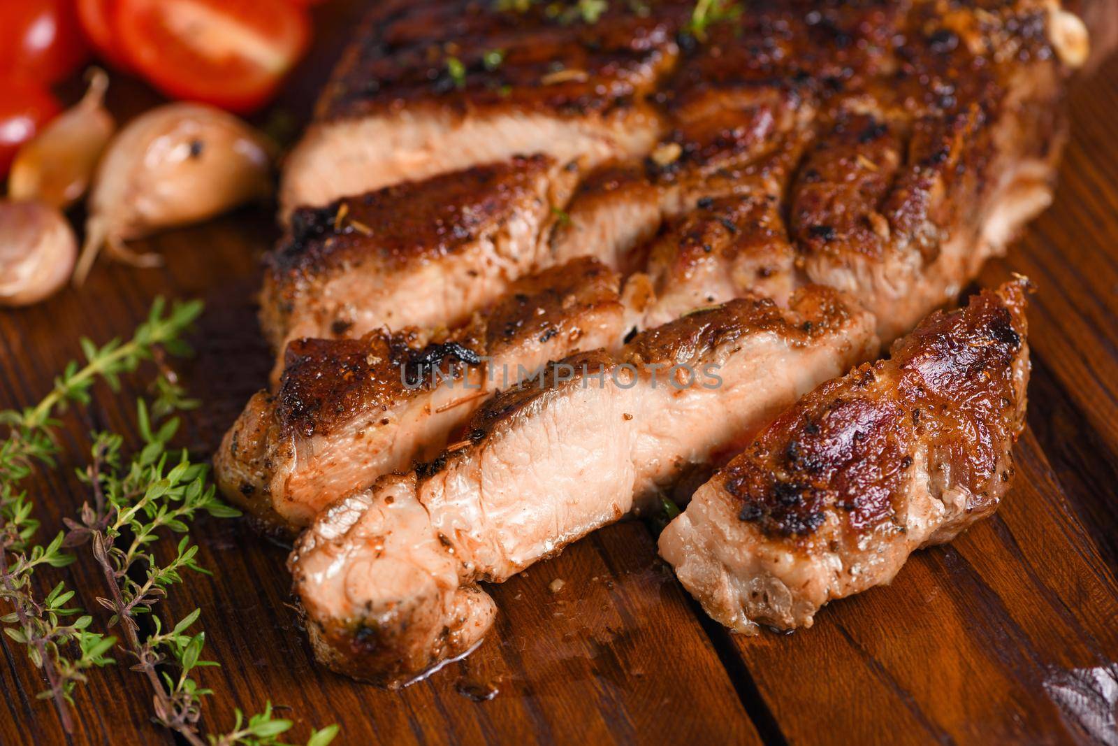 Sliced fried pork steak on a wooden board  by Apolonia