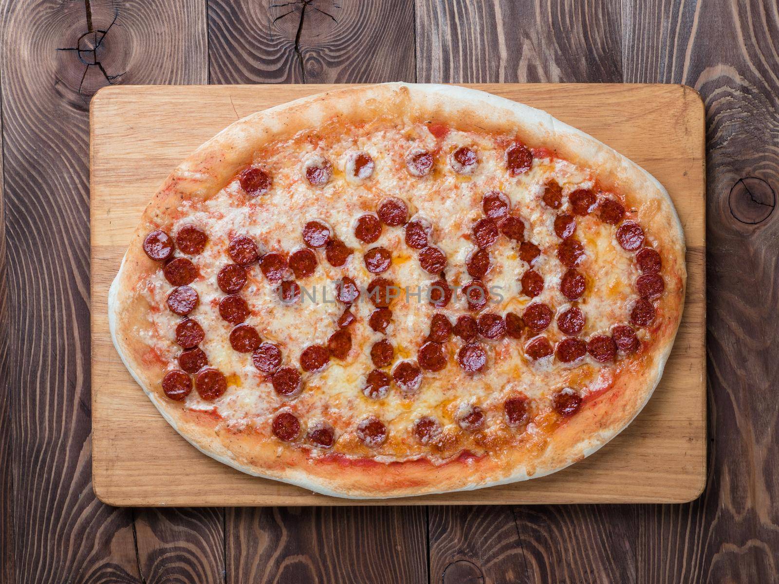 Father's day background. Pepperoni pizza with i love dad lettering on wooden tabletop. Father day concept, recipe and idea. Top view or flat-lay.