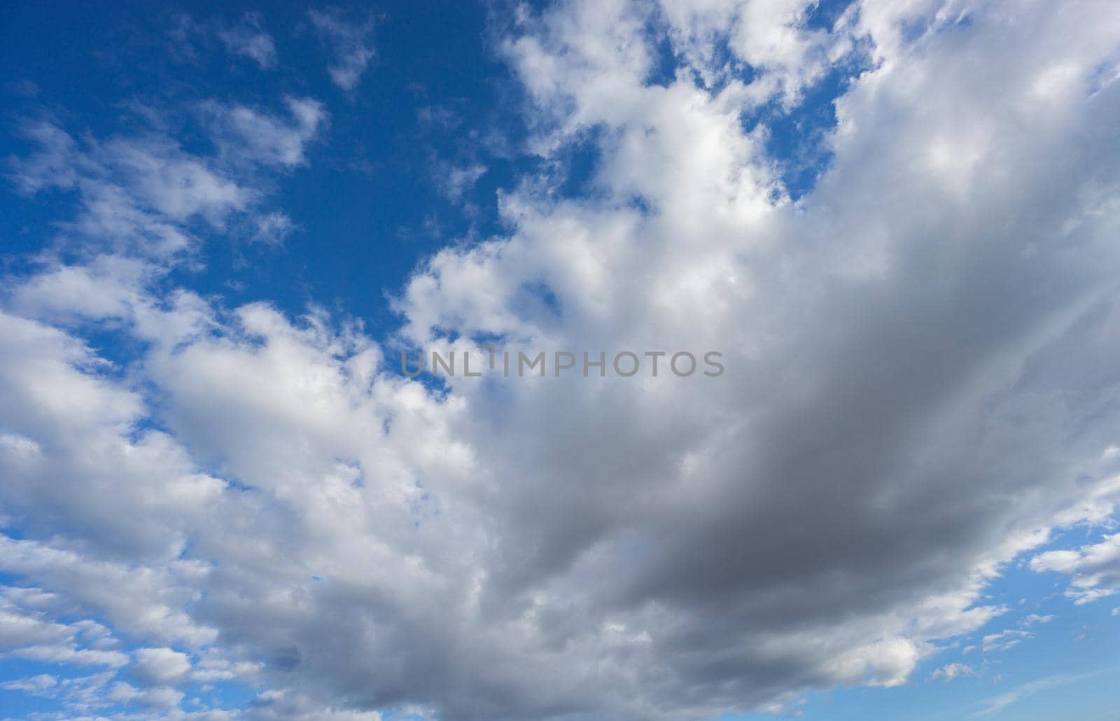 Wide angle view of big cloud over blue sky