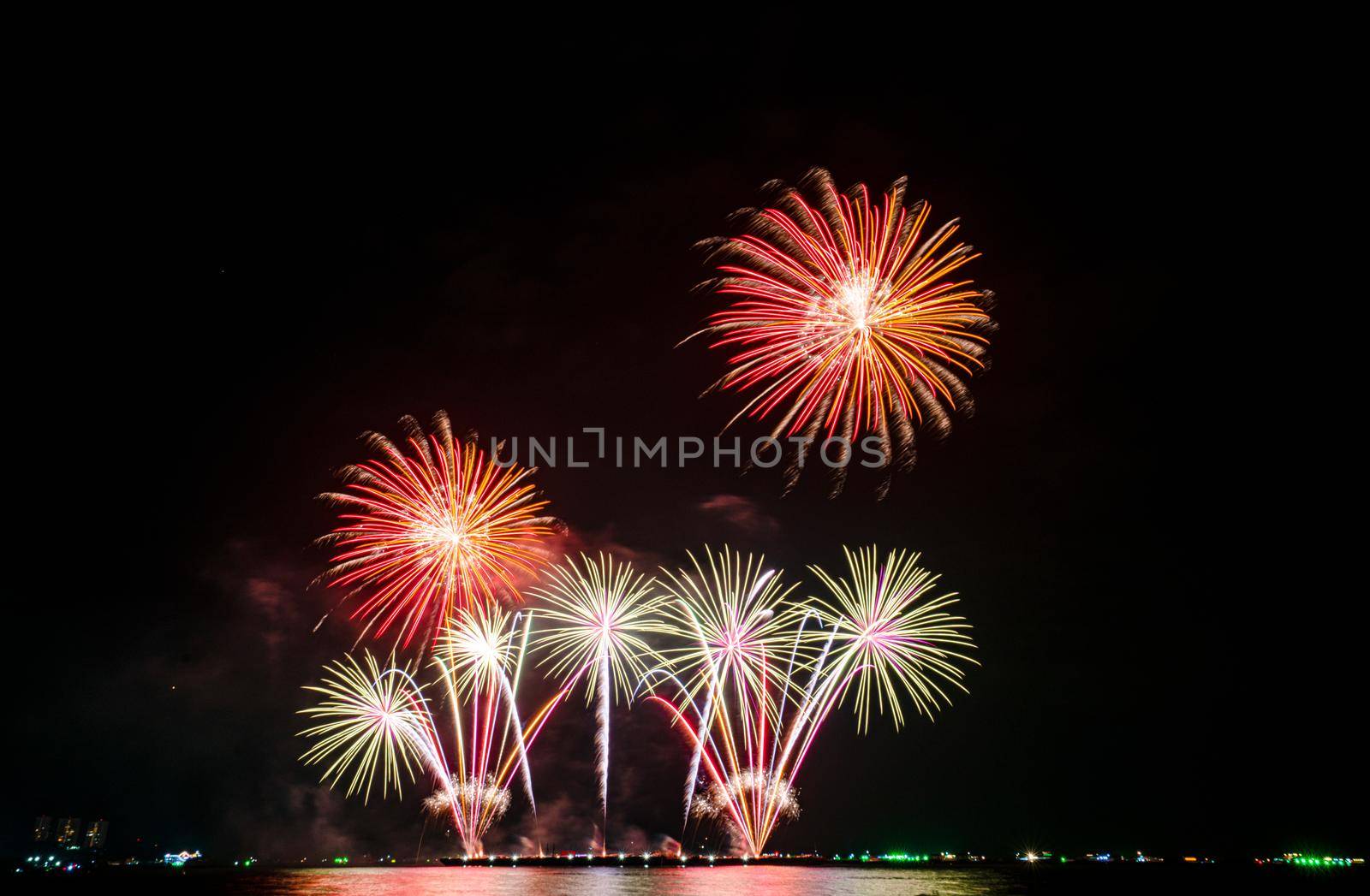 Fireworks at the sea in night time for celebration of new years by Buttus_casso