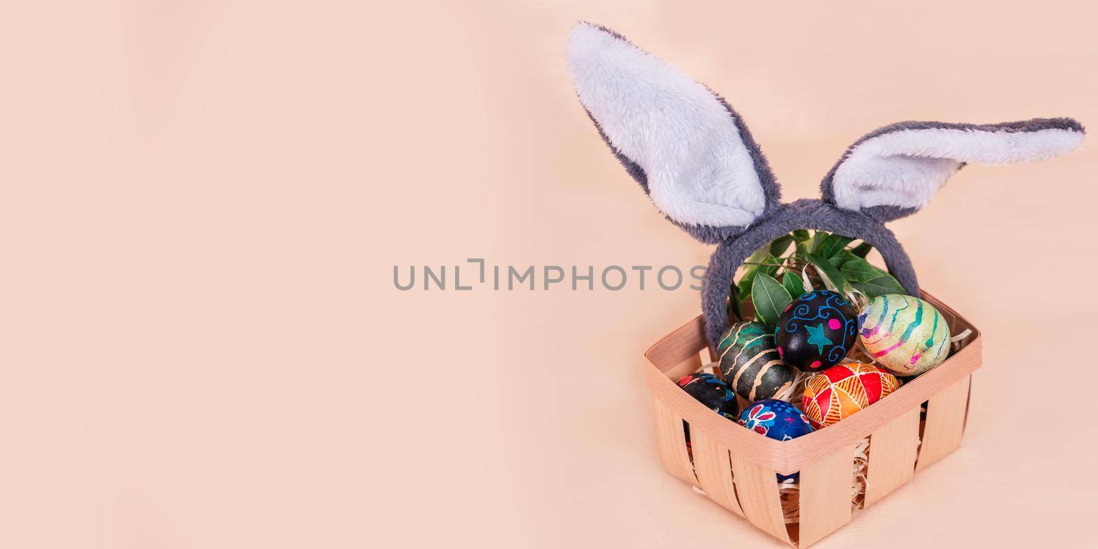 Easter basket with painted eggs banner. Easter holiday tradition. by Len44ik