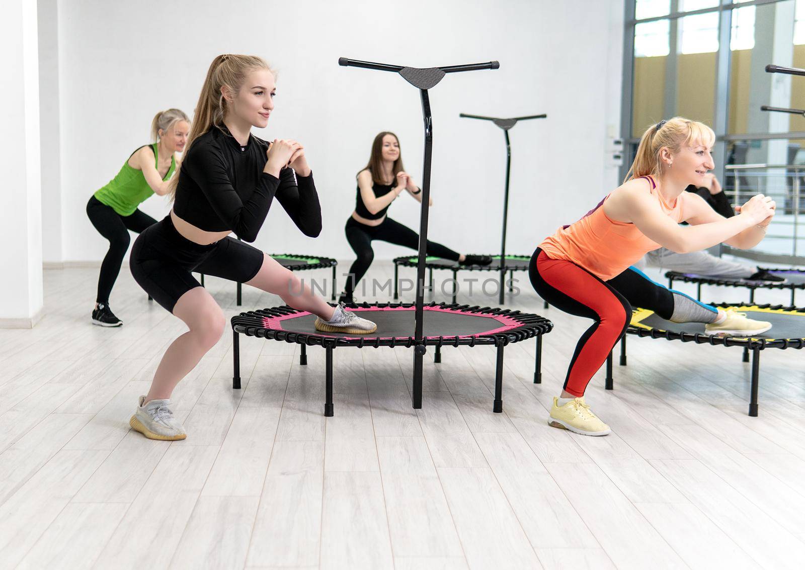 Trampoline for fitness girls are engaged in professional sports, the concept of a healthy lifestyle jumping trampoline woman fitness gym training, from exercise active from activity from energy wellness, club weight. Sportswear caucasian motion, physical