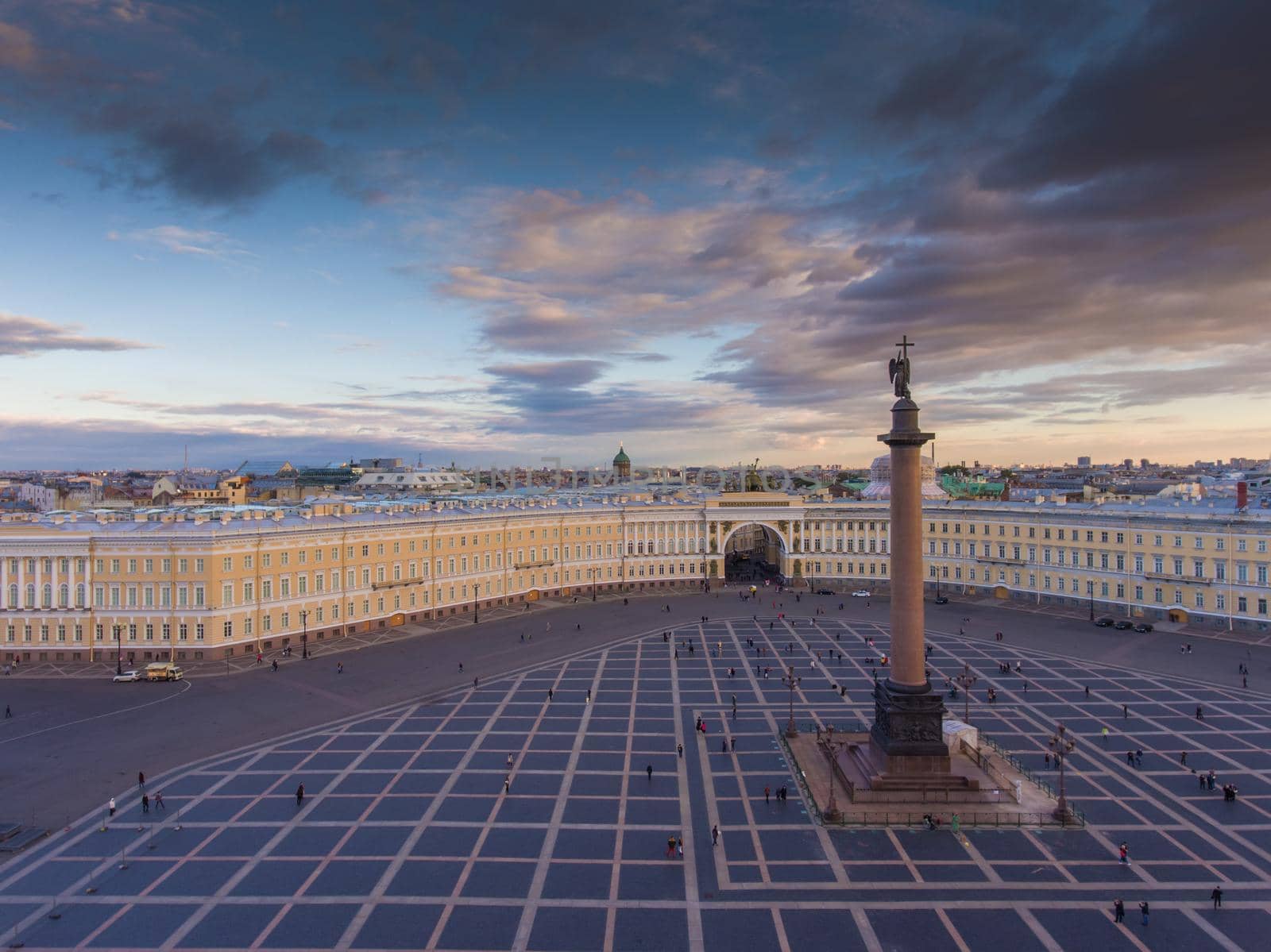 Aerial view of Palace Square and Alexander Column at sunset, a dome of Kazanskiy Cathedral on background, the Winter Palace, walking a little people. High quality photo