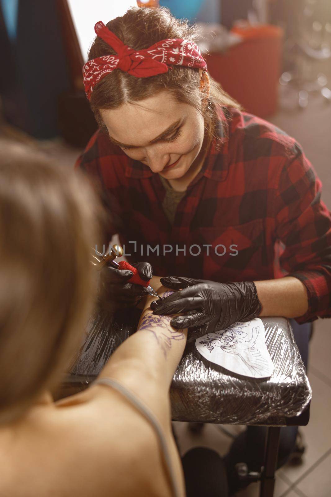 Vertical photo of tattoo master hands in gloves holding tattoo machine by Yaroslav_astakhov