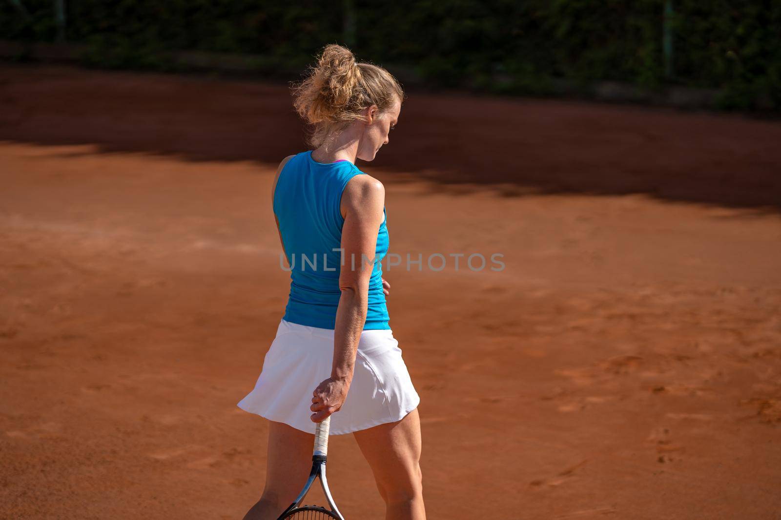 female tennis player on an outdoor clay court.