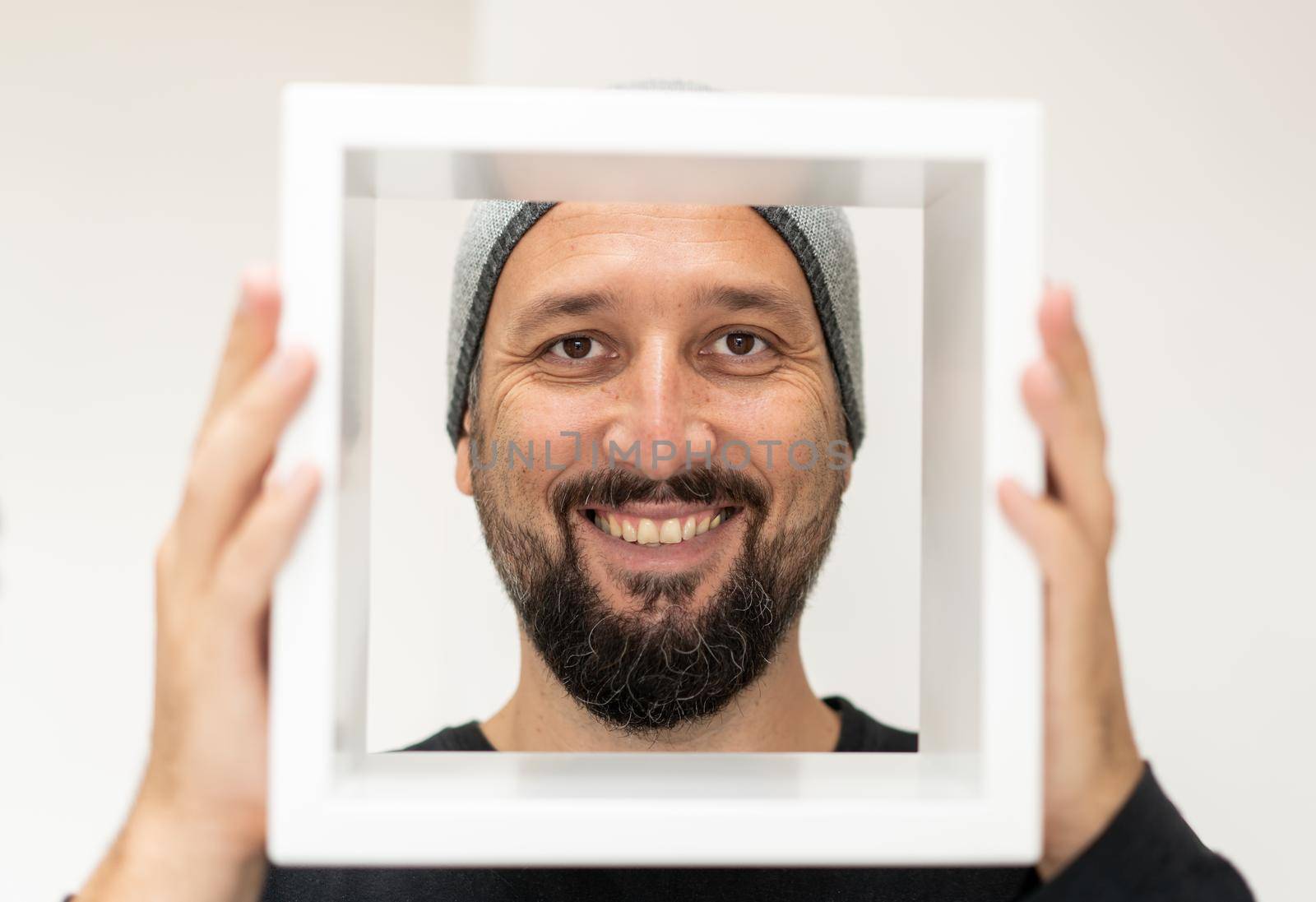 Happy adult man with frame. High quality photo