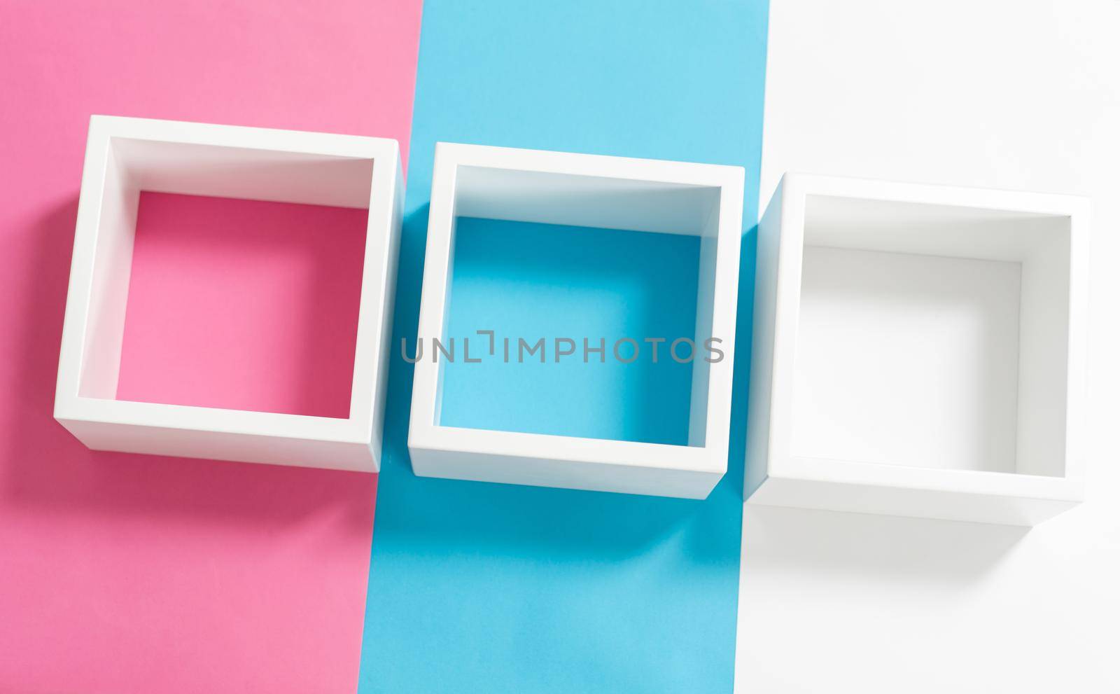 Simply design with empty white frame on pink and blue pastel colorful background. Minimal concept by Zurijeta