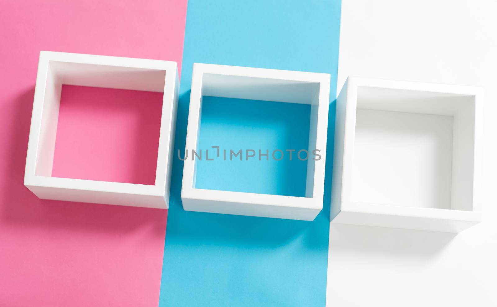 Simply design with empty blue frame isolated on pink and blue pastel colorful background. Top view, flat lay, copy space, mock up.