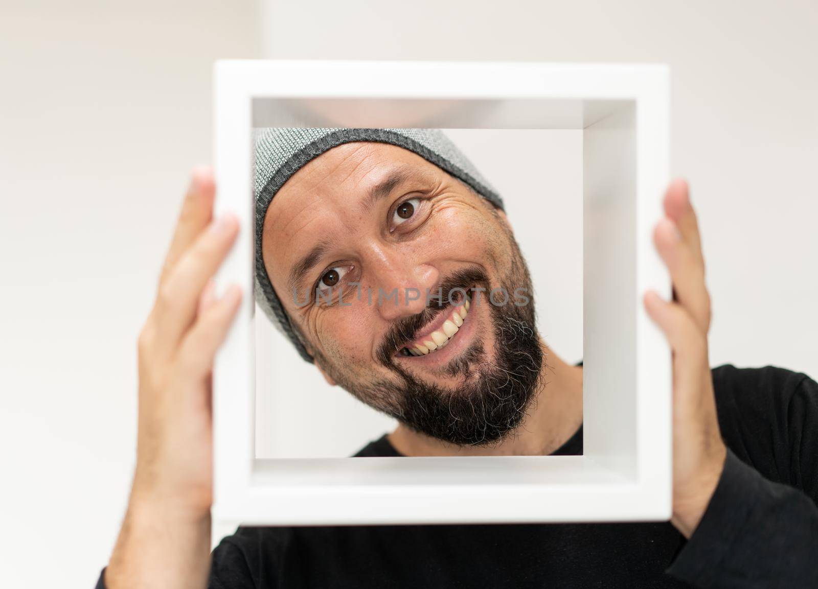 Happy adult man with frame. High quality photo