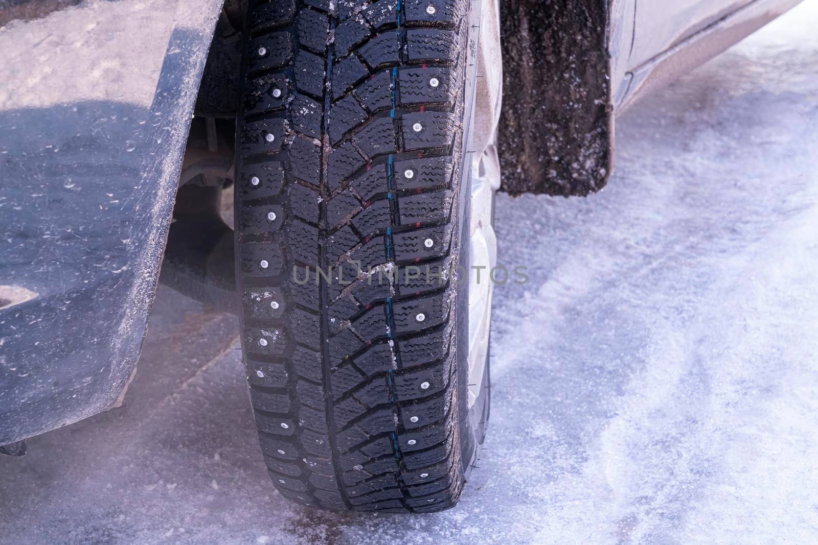 a car wheel with spikes in the snow. High quality photo