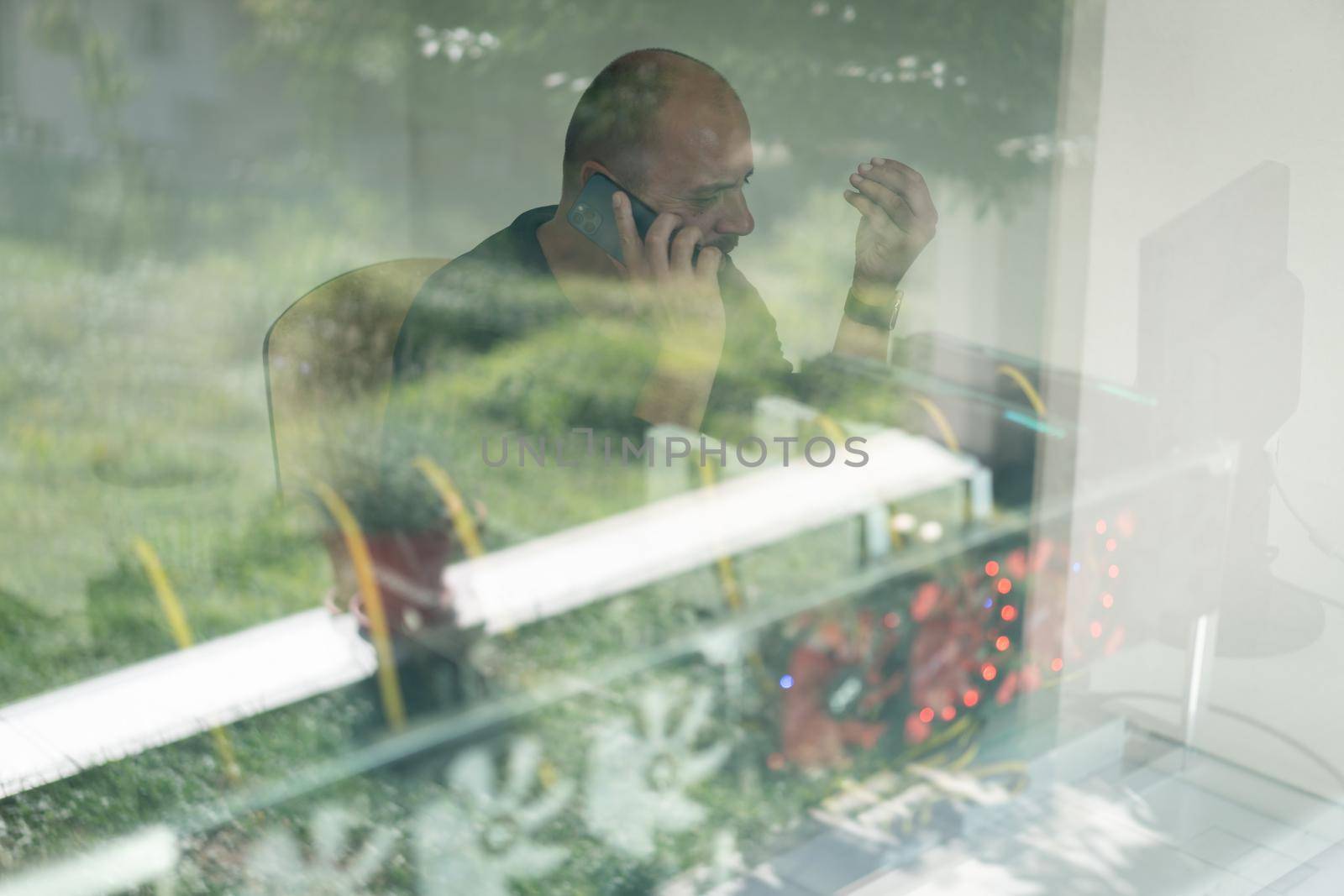 Young programmer adjusting cryptocurrency mining rig to optimal operational settings. High quality photo