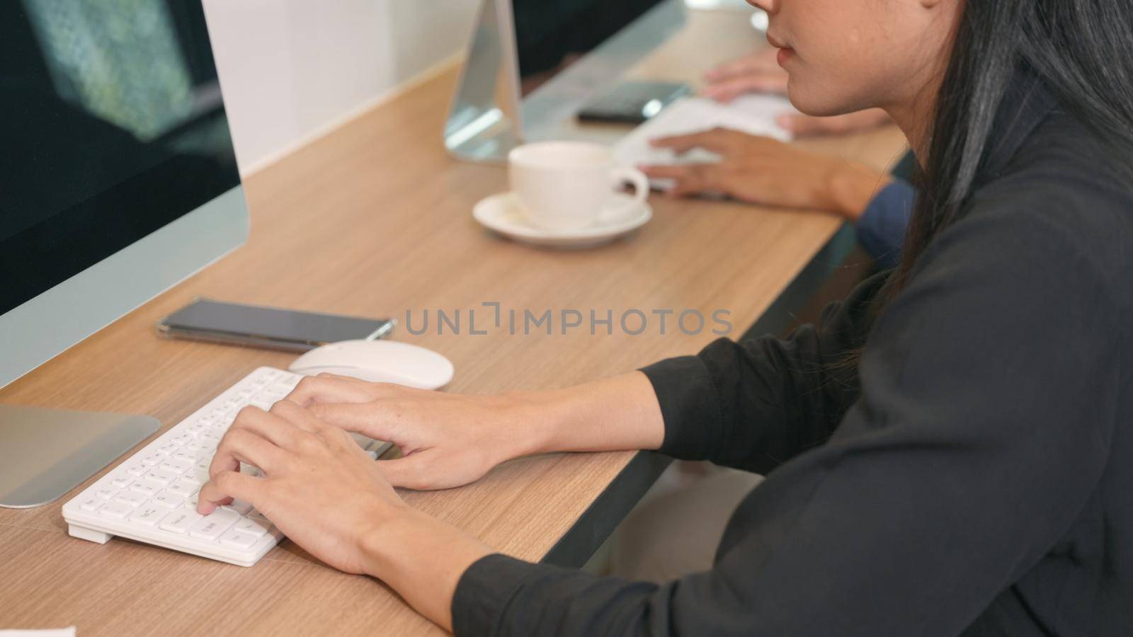 Close up the woman hand typing message on keyboard of PC computer on desk in office, female writing a blog on keyboard and chatting friend search information form internet while working