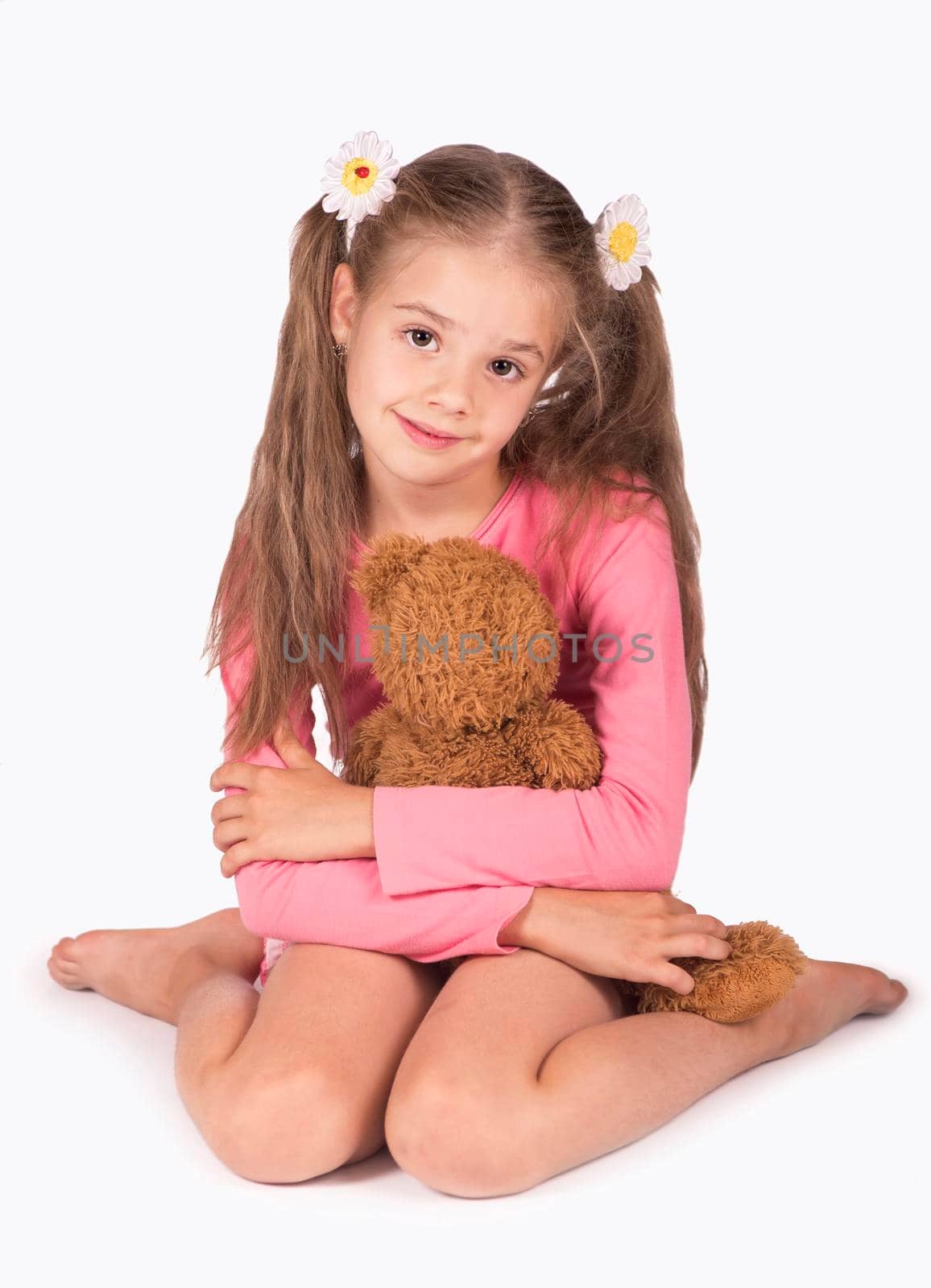 Happy girl with teddy bears isolated on white
