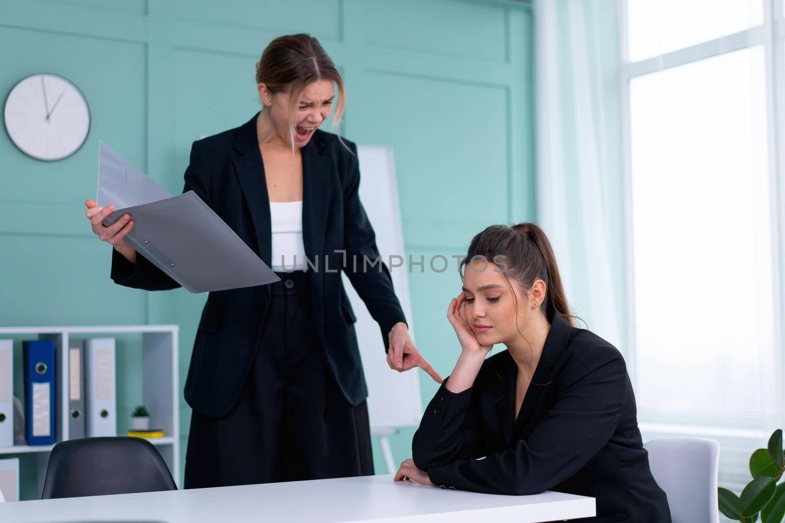 Boss screaming at frustrated employee, bullying and emotional abuse at work. Toxic work environment. Angry female irate boss yelling and shouting at his secretary employee. CEO rebuke for deadline