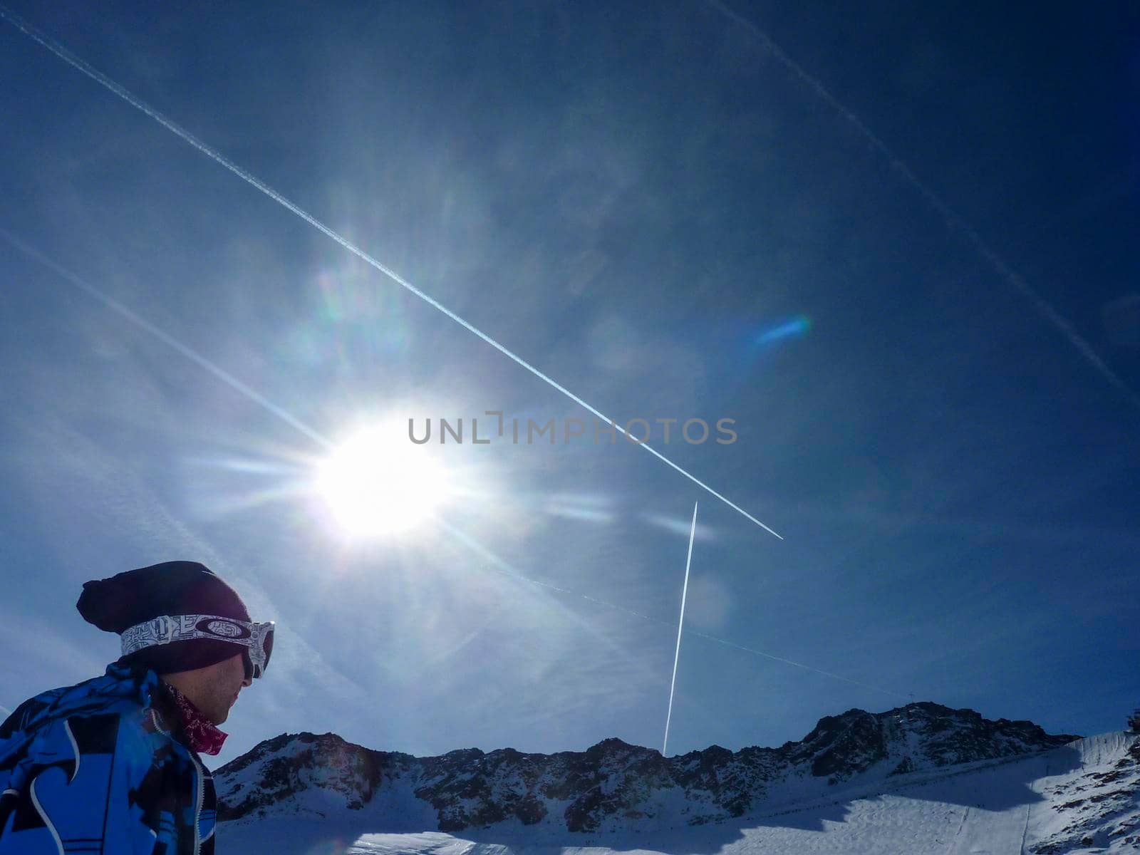 skier with cap looks at the blue sky in Val Senales. High quality photo