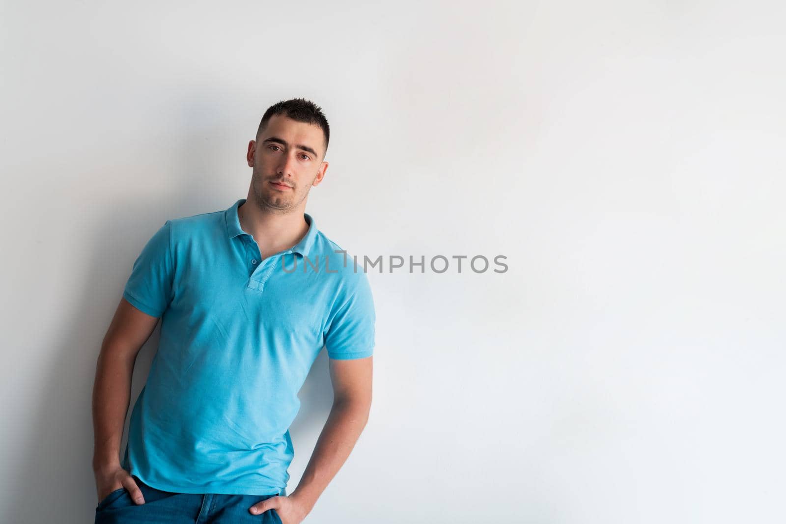 Formal business male portrait. A confident successful casual businessman or manager stands in front of a white background. High-quality photo