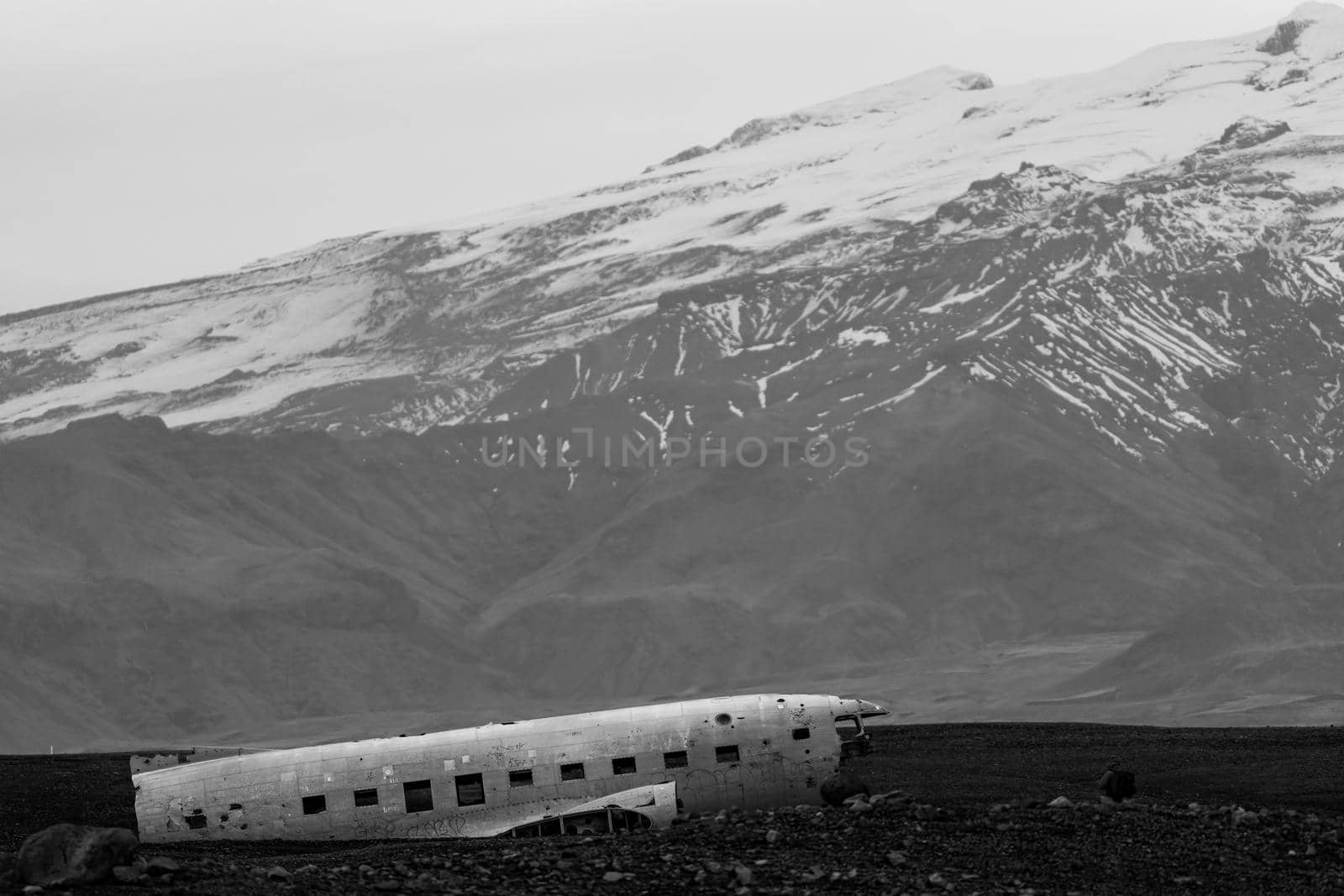 Wreck of and airplane profile and mountains in the background