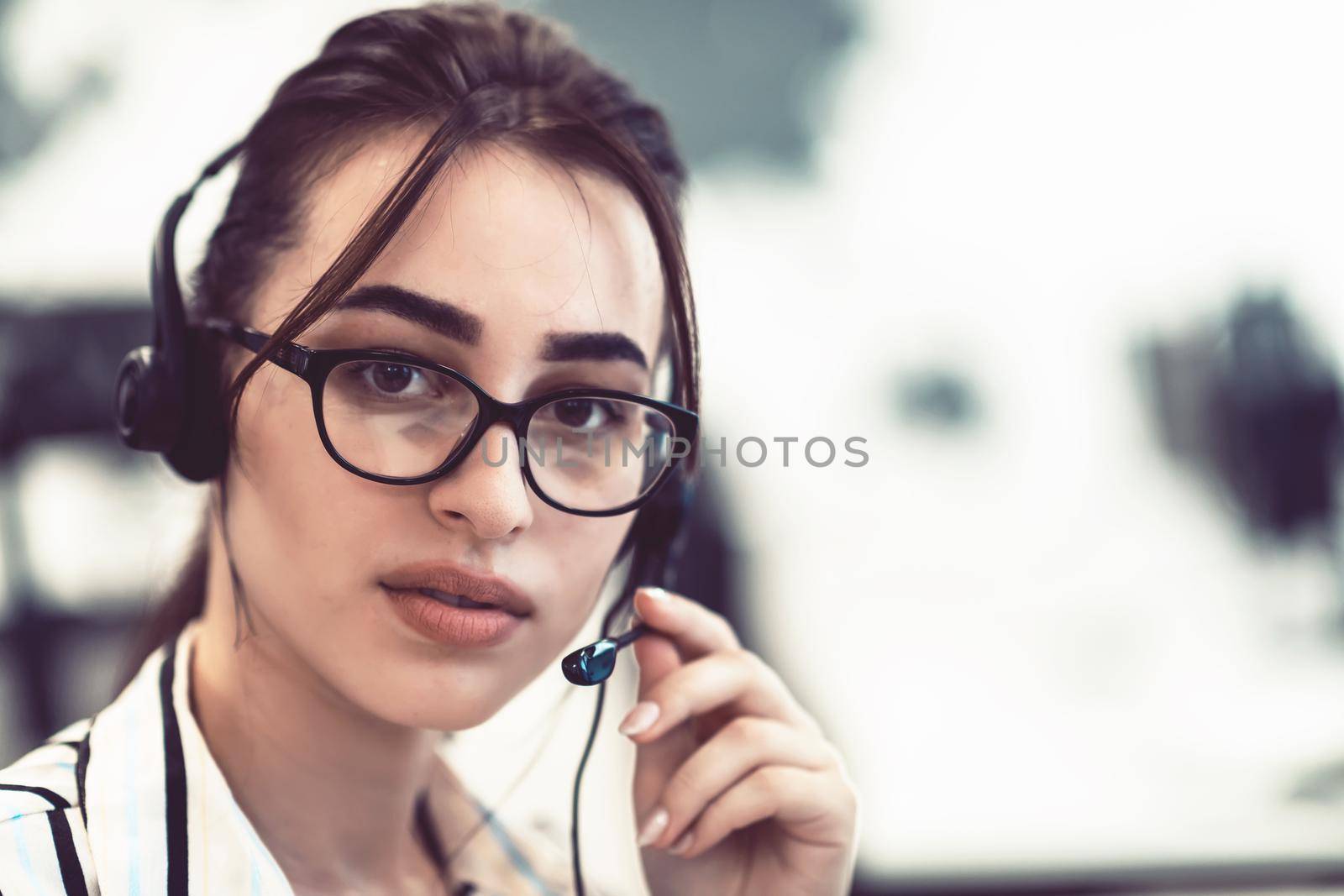 Business and technology concept - helpline female operator with headphones in call centre .Business woman with headsets working in a call center by dotshock