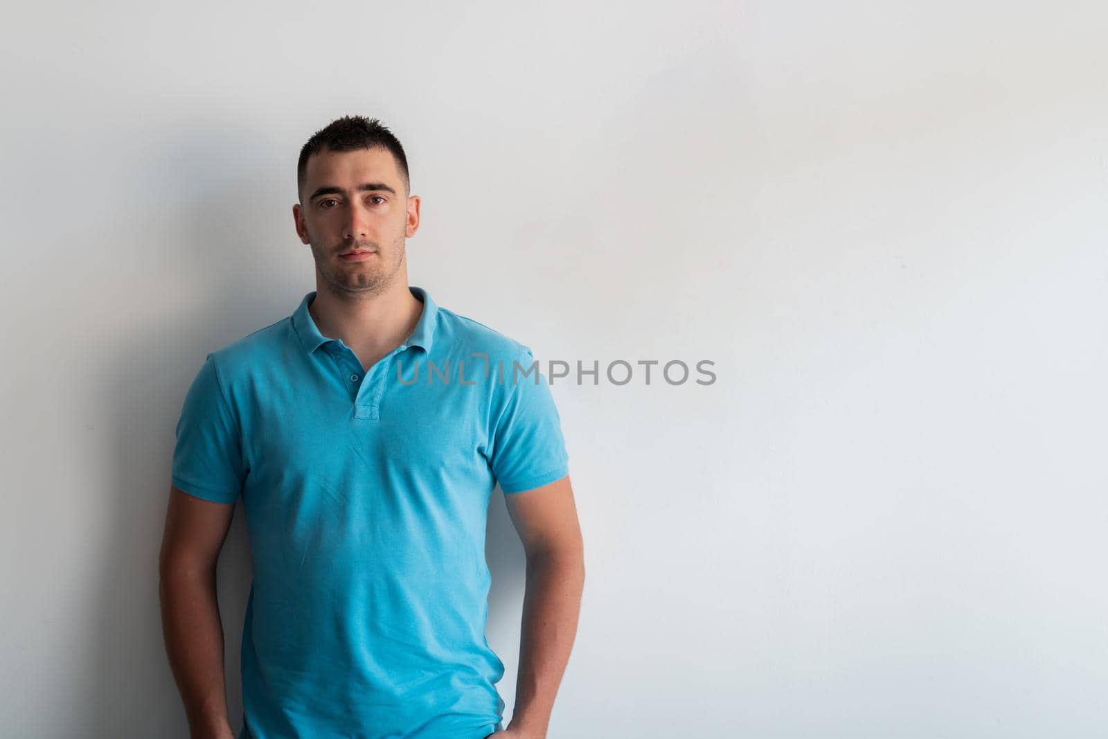 Formal business male portrait. A confident successful casual businessman or manager stands in front of a white background. by dotshock