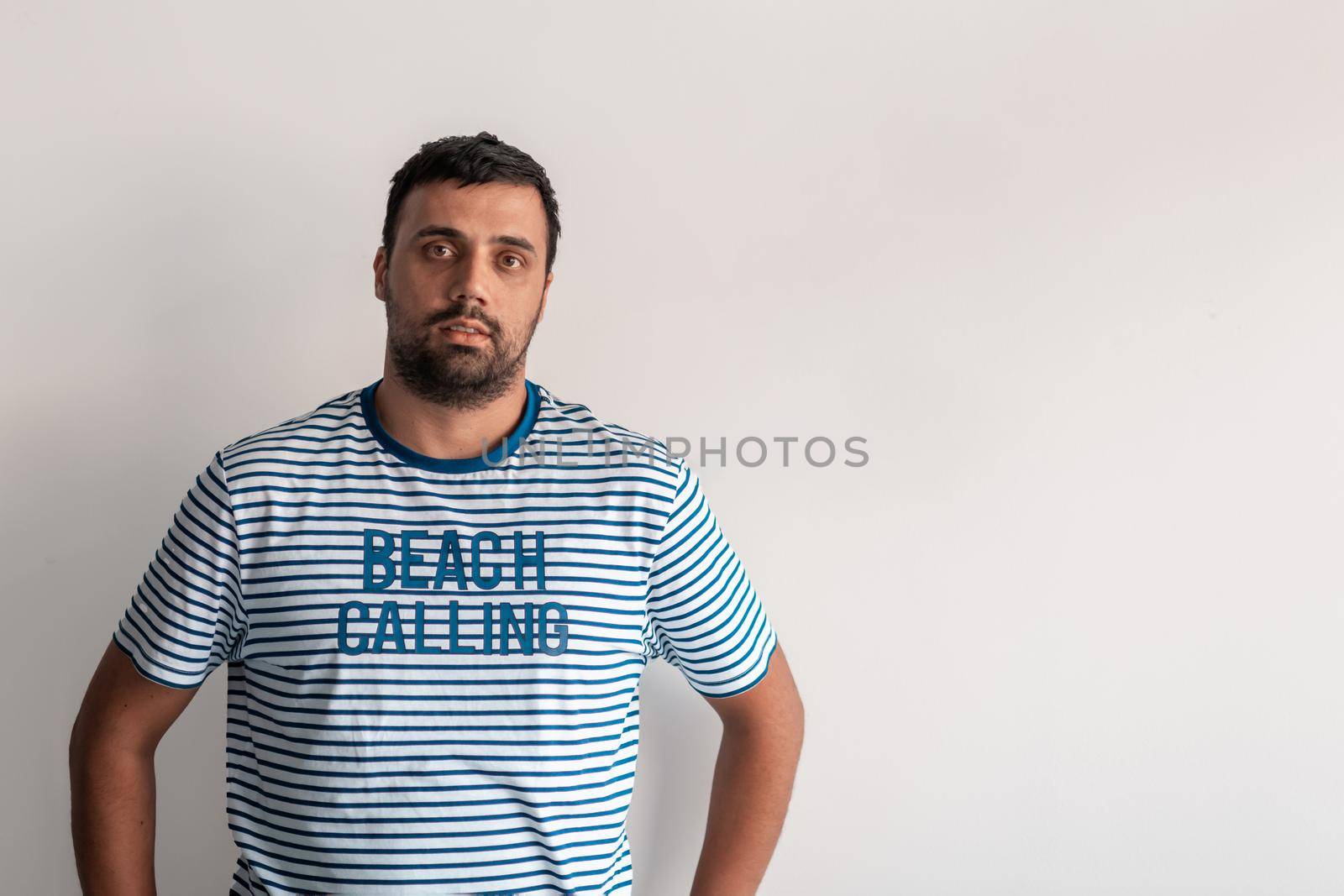 Formal business male portrait. A confident successful casual businessman or manager stands in front of a white background. High-quality photo