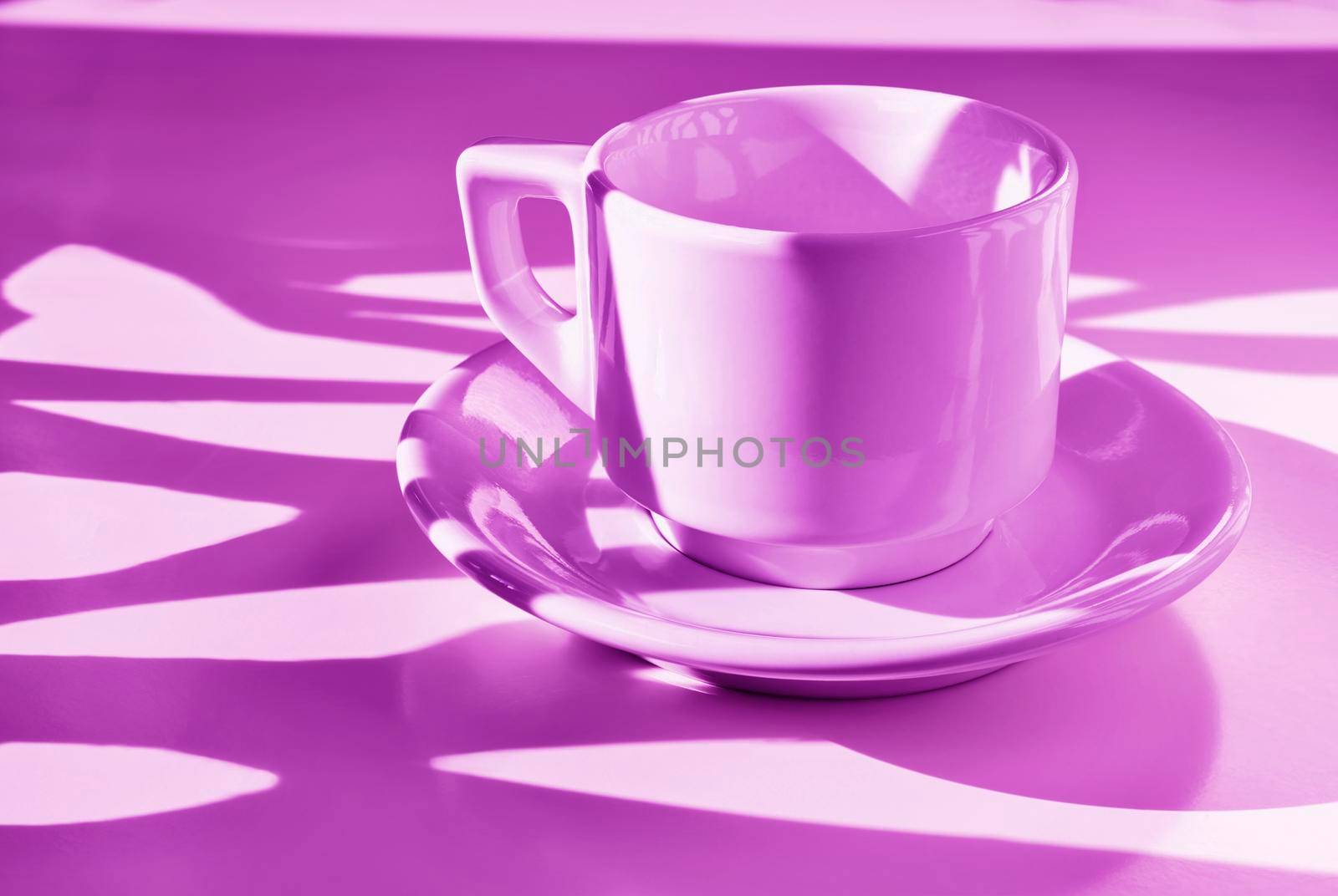 White cup of coffee on pink background ,  long shadows on cup , break time