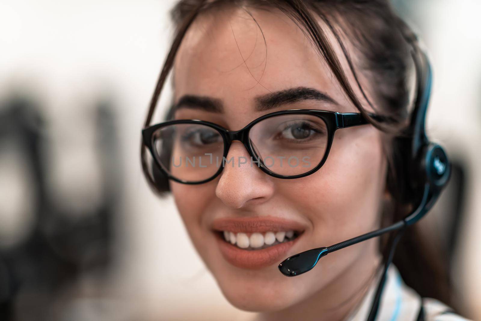 Business and technology concept - helpline female operator with headphones in call centre .Business woman with headsets working in a call center by dotshock