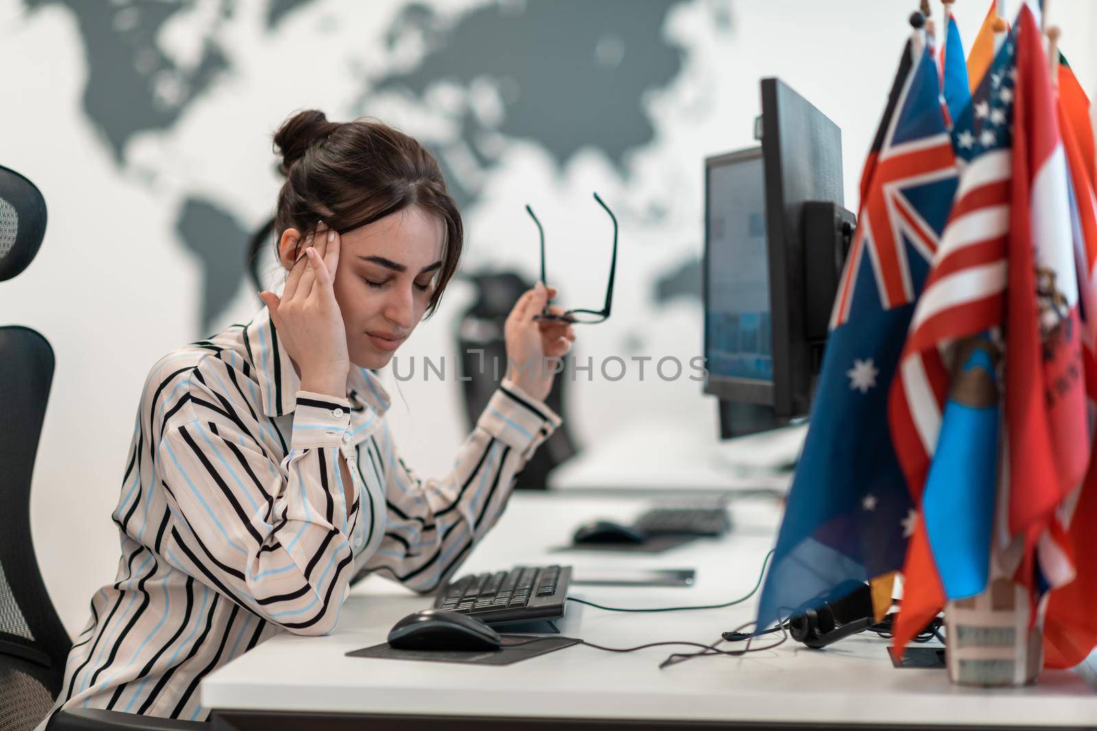 Beautiful Shocked and Annoyed Young Woman Looking her Laptop. Sad Operator Agent Woman Working from Home in a Call Center by dotshock