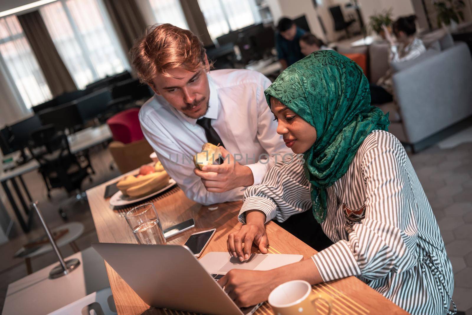 International multicultural business team. A young businessman and businesswoman sit in a modern relaxation space and talk about a new business. High-quality photo