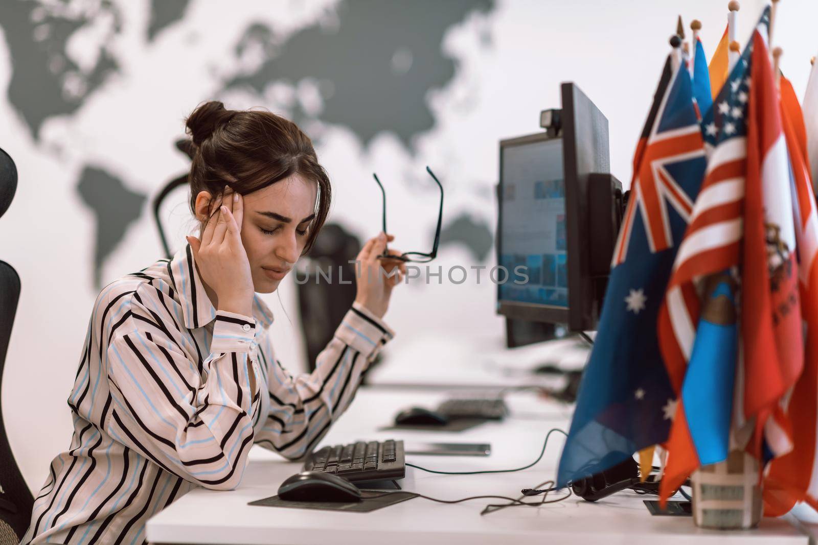 Beautiful Shocked and Annoyed Young Woman Looking her Laptop. Sad Operator Agent Woman Working from Home in a Call Center by dotshock