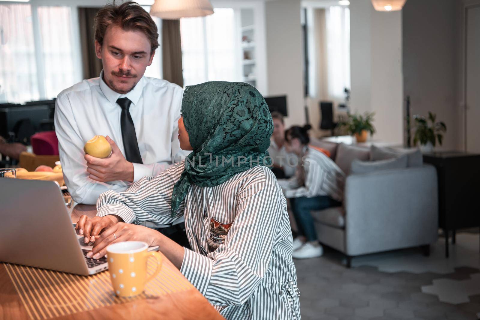 International multicultural business team. A young businessman and businesswoman sit in a modern relaxation space and talk about a new business. High-quality photo