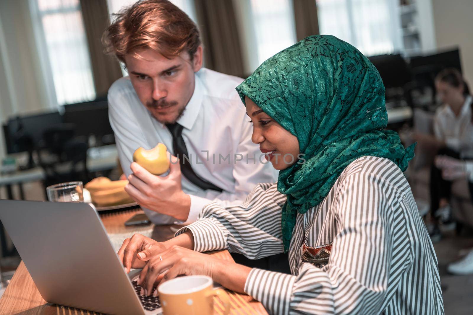 International multicultural business team. A young businessman and businesswoman sit in a modern relaxation space and talk about a new business. High-quality photo