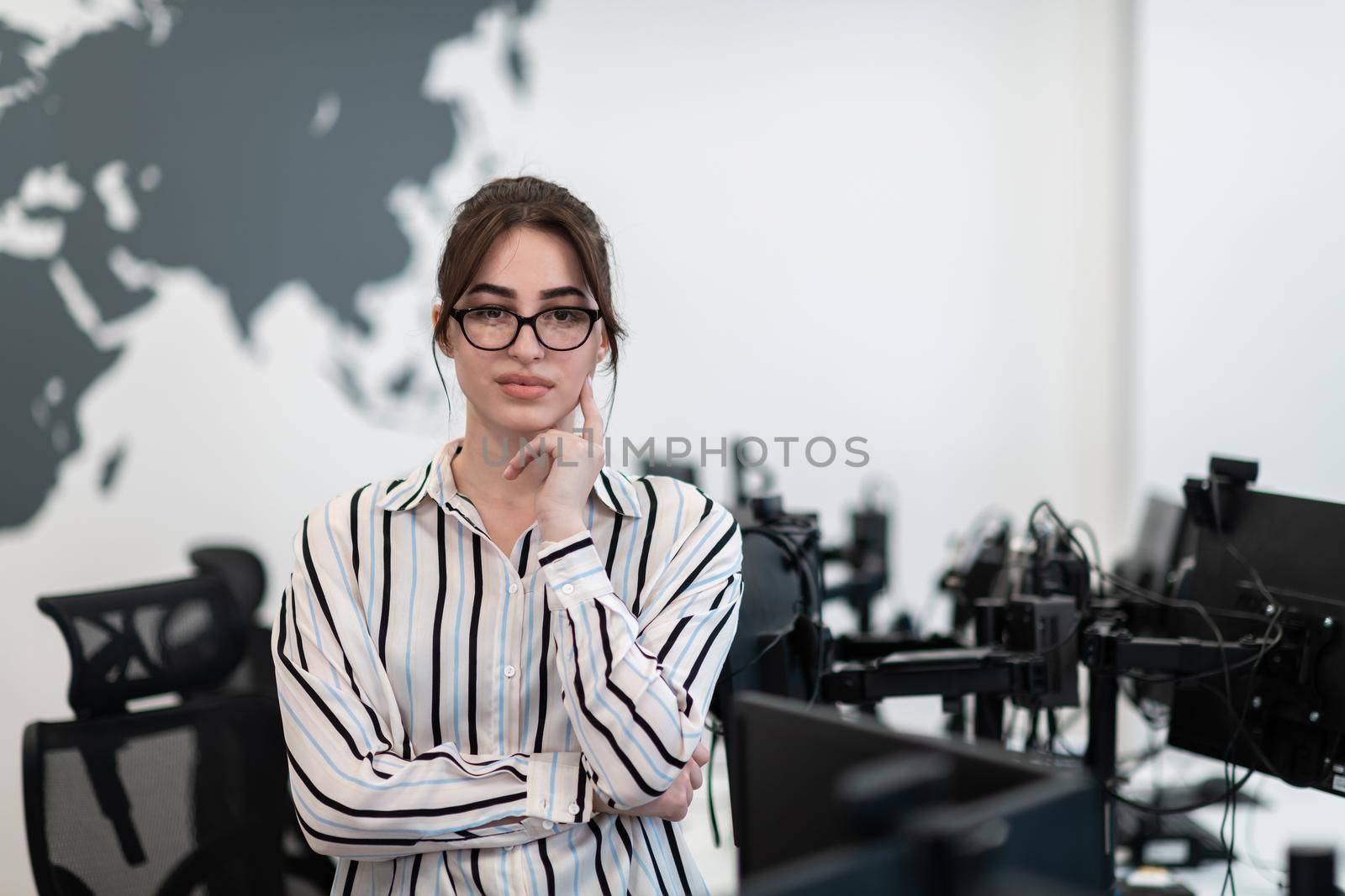 Portrait of businesswoman in casual clothes with glasses at modern startup open plan office interior. Selective focus by dotshock