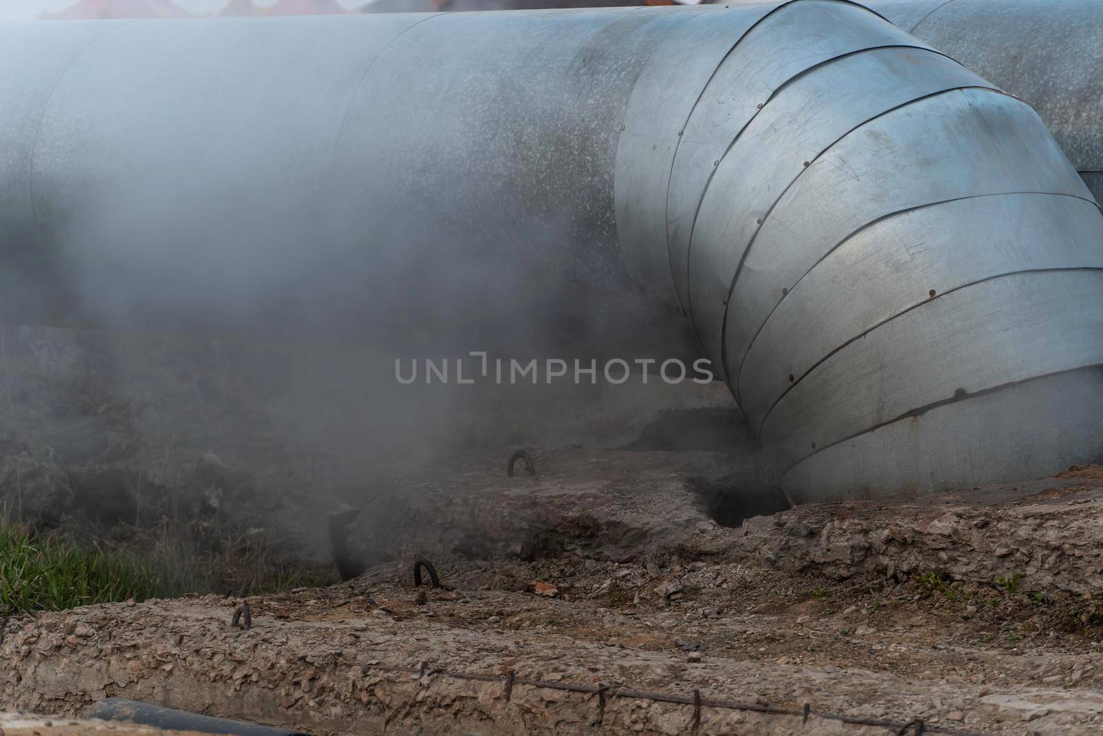 A large water pipe has burst and thick steam is coming out.A broken hot water or heating pipe.Urban communications and drainage systems.Dirty air from sewage systems and water supply.Rupture pipes by YevgeniySam