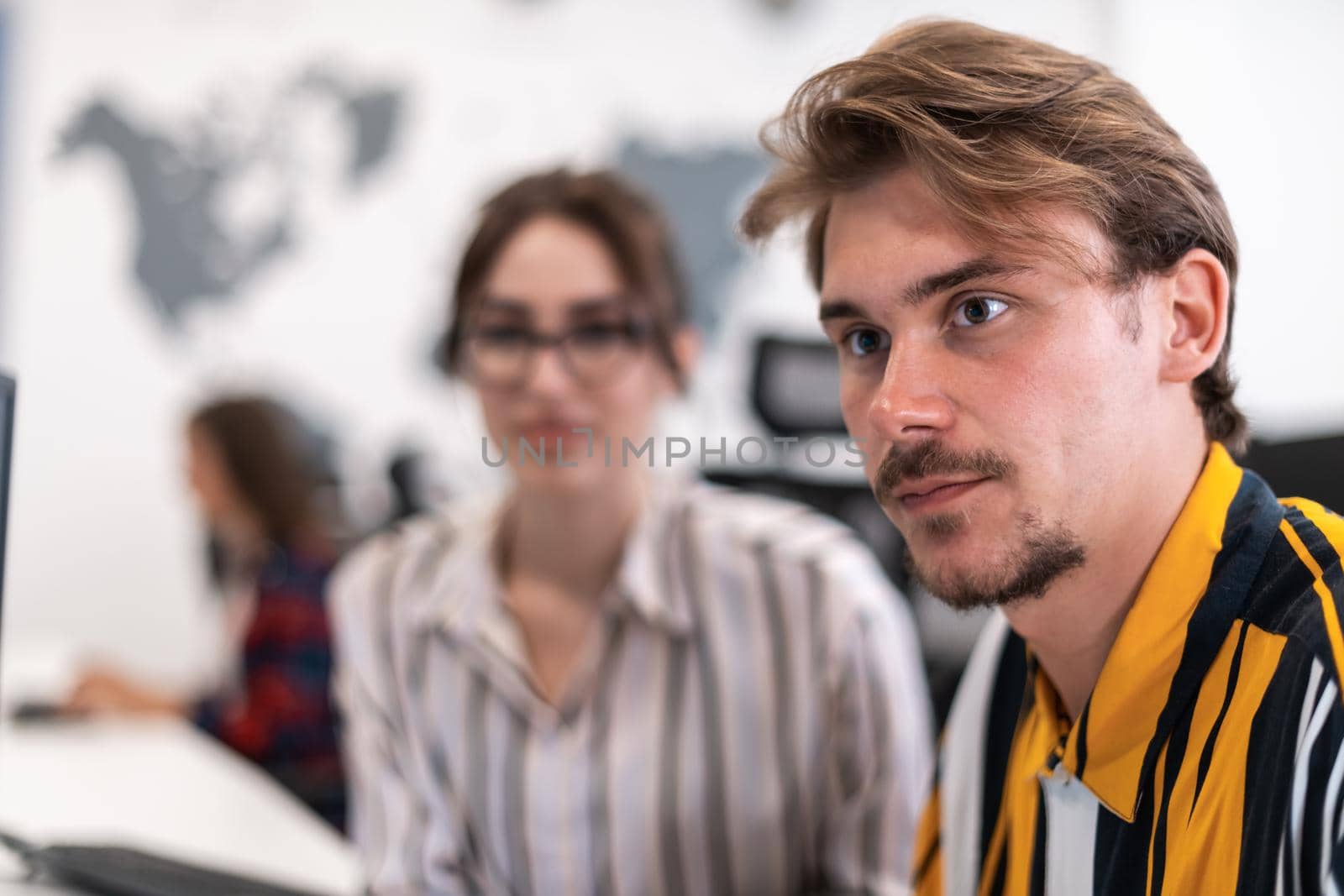 Business couple working together on project using tablet and desktop computer at modern open plan startup office. Selective focus by dotshock