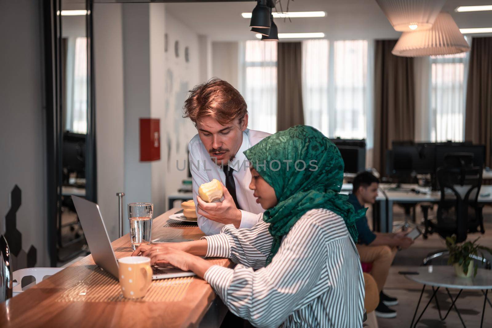 International multicultural business team. A young businessman and businesswoman sit in a modern relaxation space and talk about a new business. High-quality photo