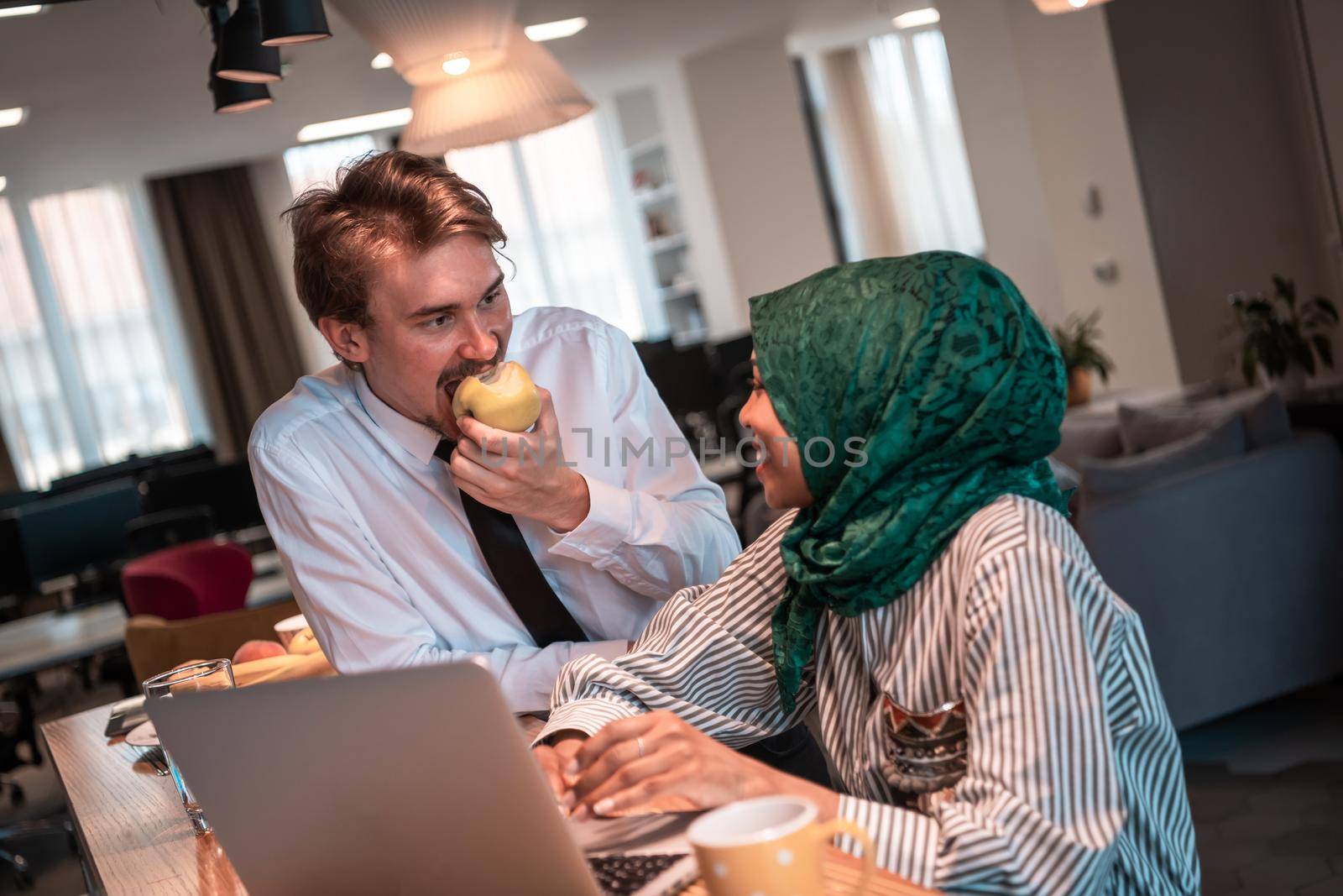 International multicultural business team. A young businessman and businesswoman sit in a modern relaxation space and talk about a new business. High-quality photo