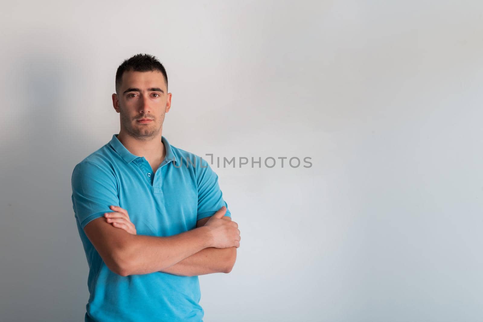 man wearing casual clothes happy face smiling with crossed arms looking at the camera. positive person. by dotshock