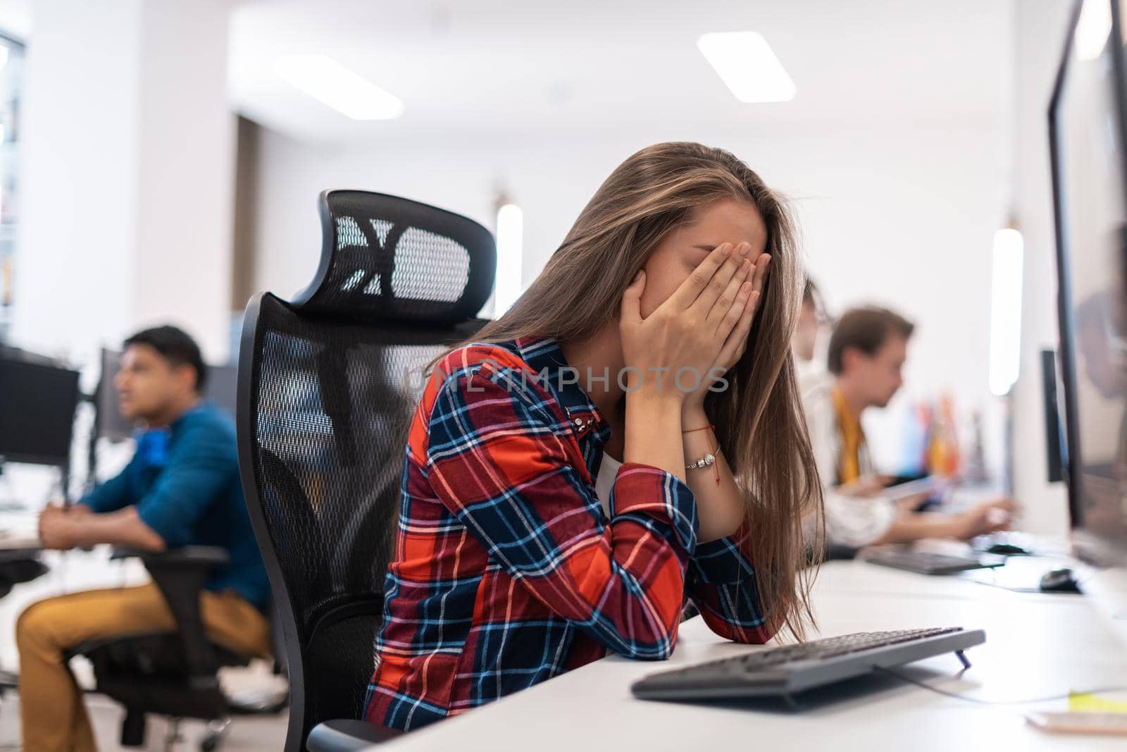 Beautiful Shocked and Annoyed Young Woman Looking at her desktop. Sad Operator Agent Woman Working from Home in a Call Center. High-quality photo