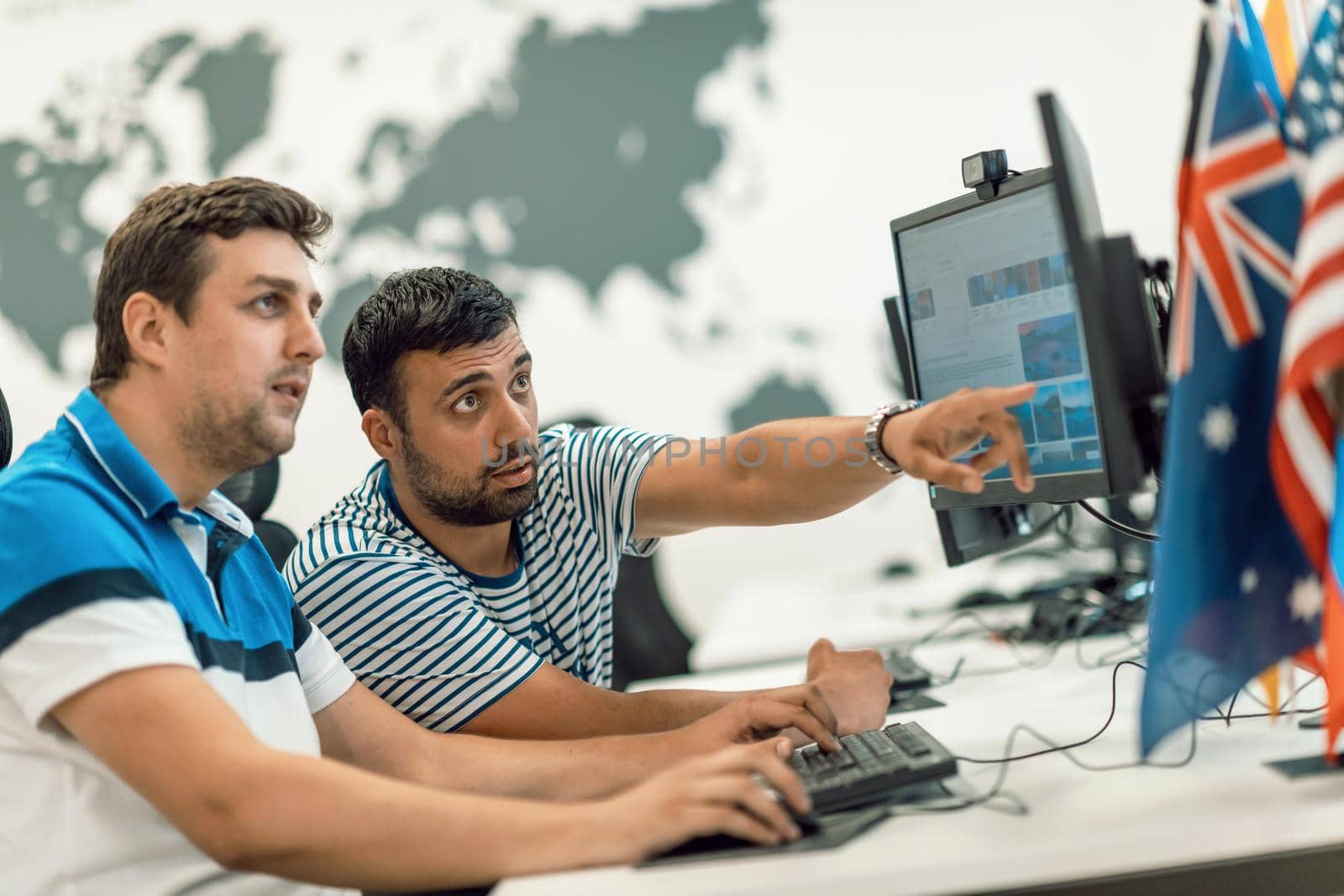 Group of Casual business man working on desktop computer in modern open plan startup office interior. Selective focus by dotshock