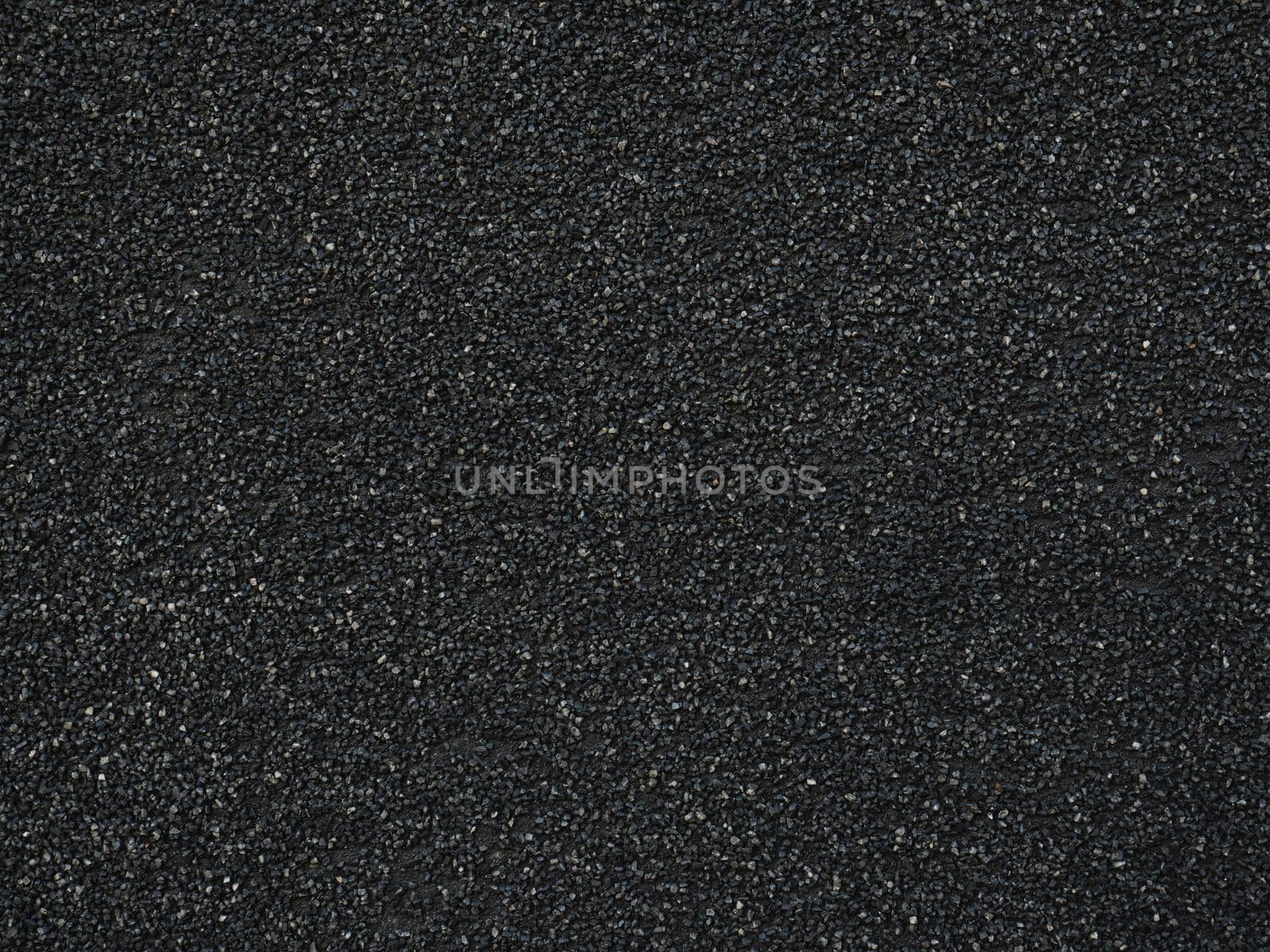 Black rough backdrop. Smooth asphalt road. Tarmac texture. Top view. Stucco surface. Dark abstract pattern.