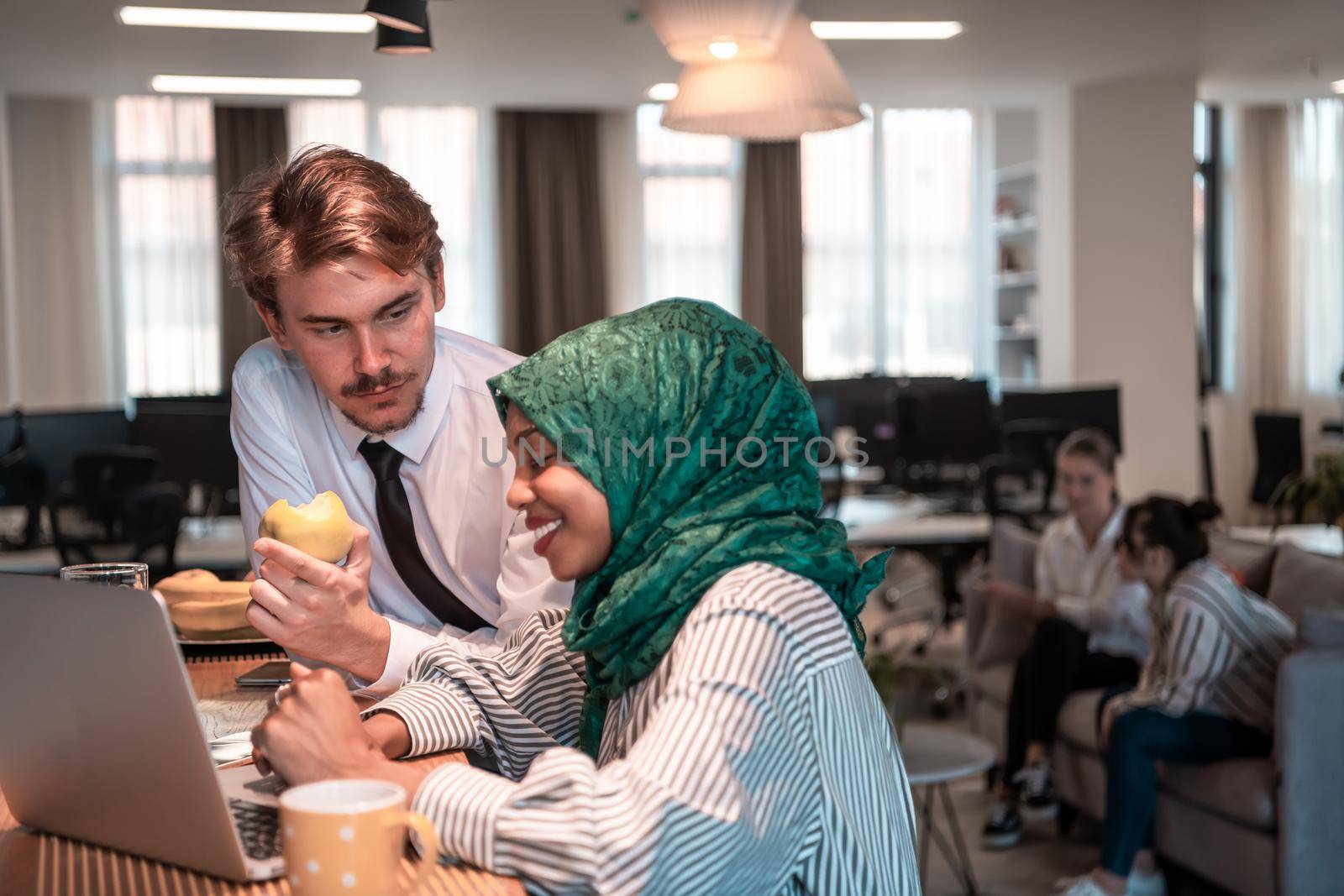 International multicultural business team. A young businessman and businesswoman sit in a modern relaxation space and talk about a new business. High-quality photo